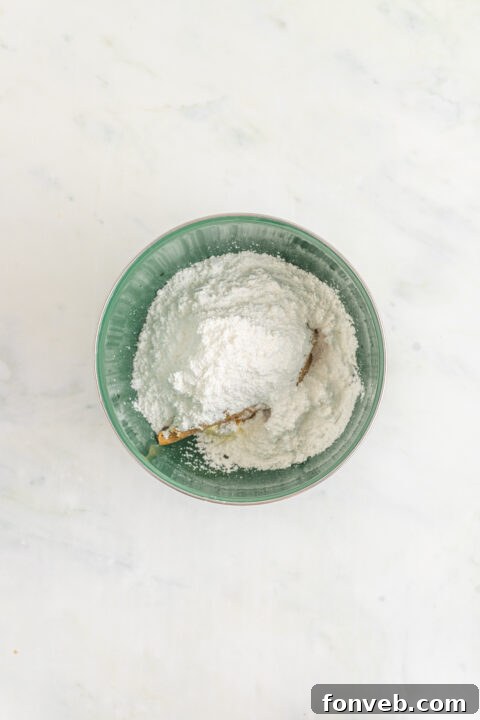 Peanut butter frosting ingredients in a stand mixer.