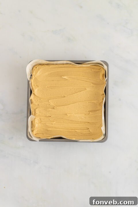 Smooth peanut butter frosting in a bowl.
