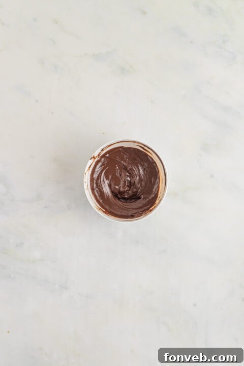 Chocolate chips and warm heavy cream for ganache preparation.