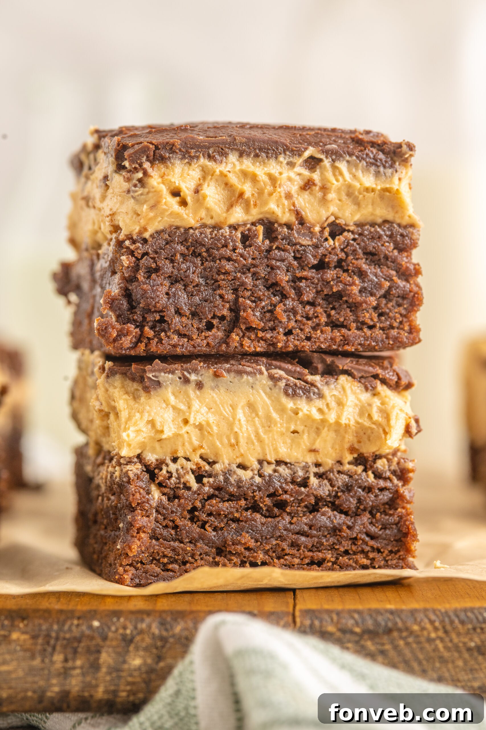 A close-up shot of two perfectly layered Buckeye Brownies, stacked one on top of the other.