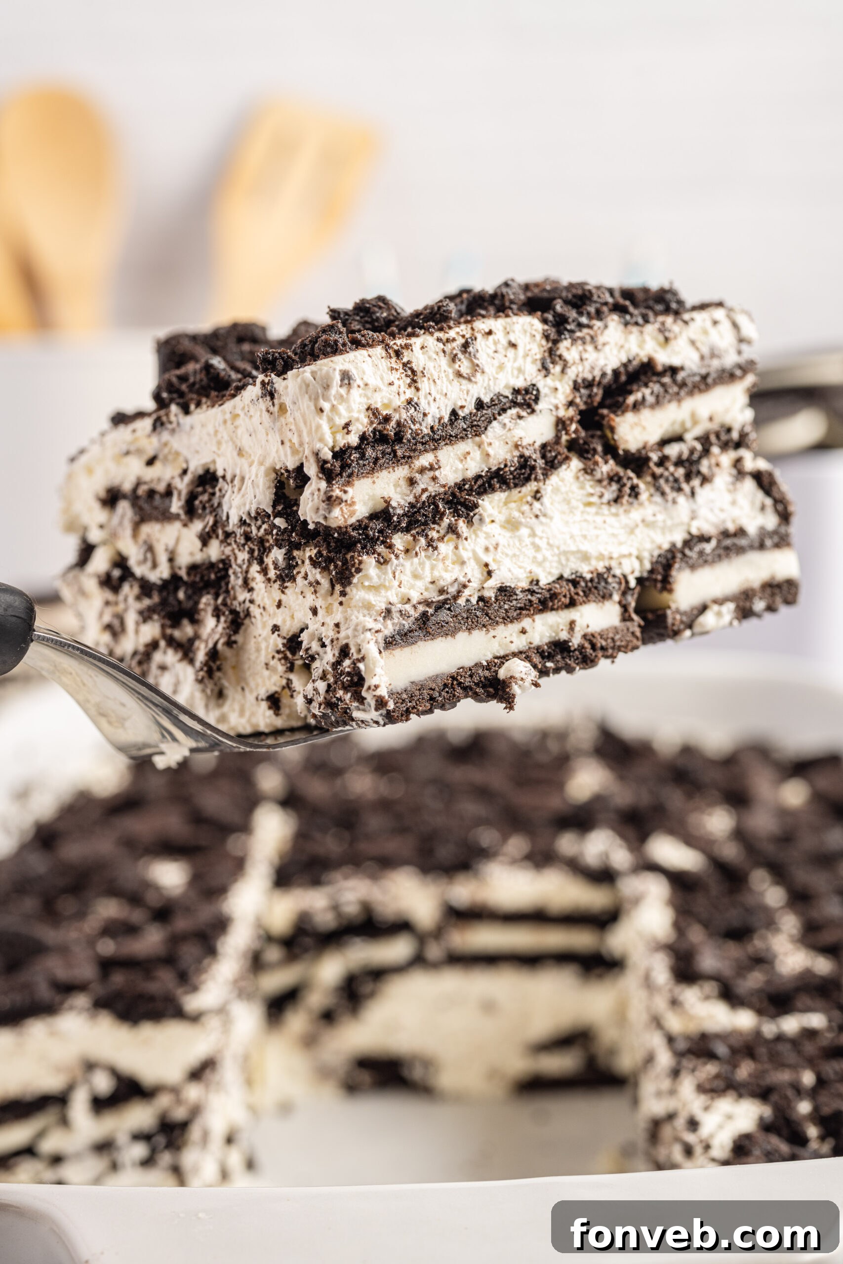Front view of a slice of Oreo Icebox Cake on a silver cake server.