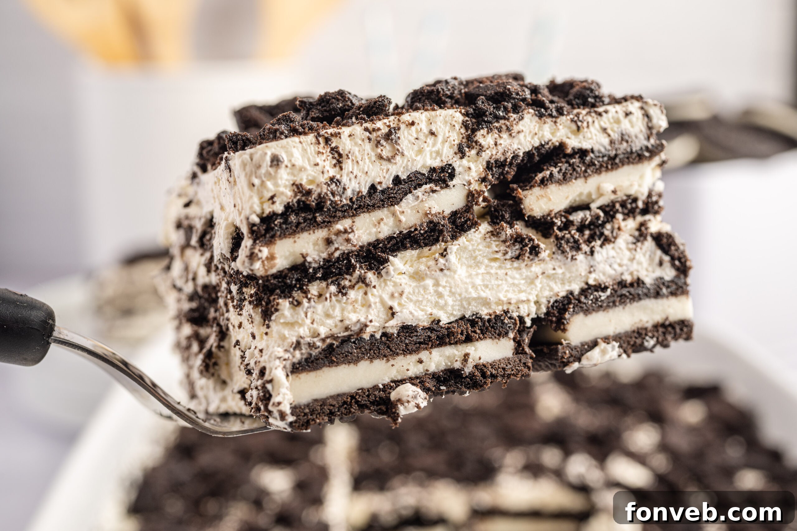 Slice of the Oreo Icebox Cake being lifted out of the pan