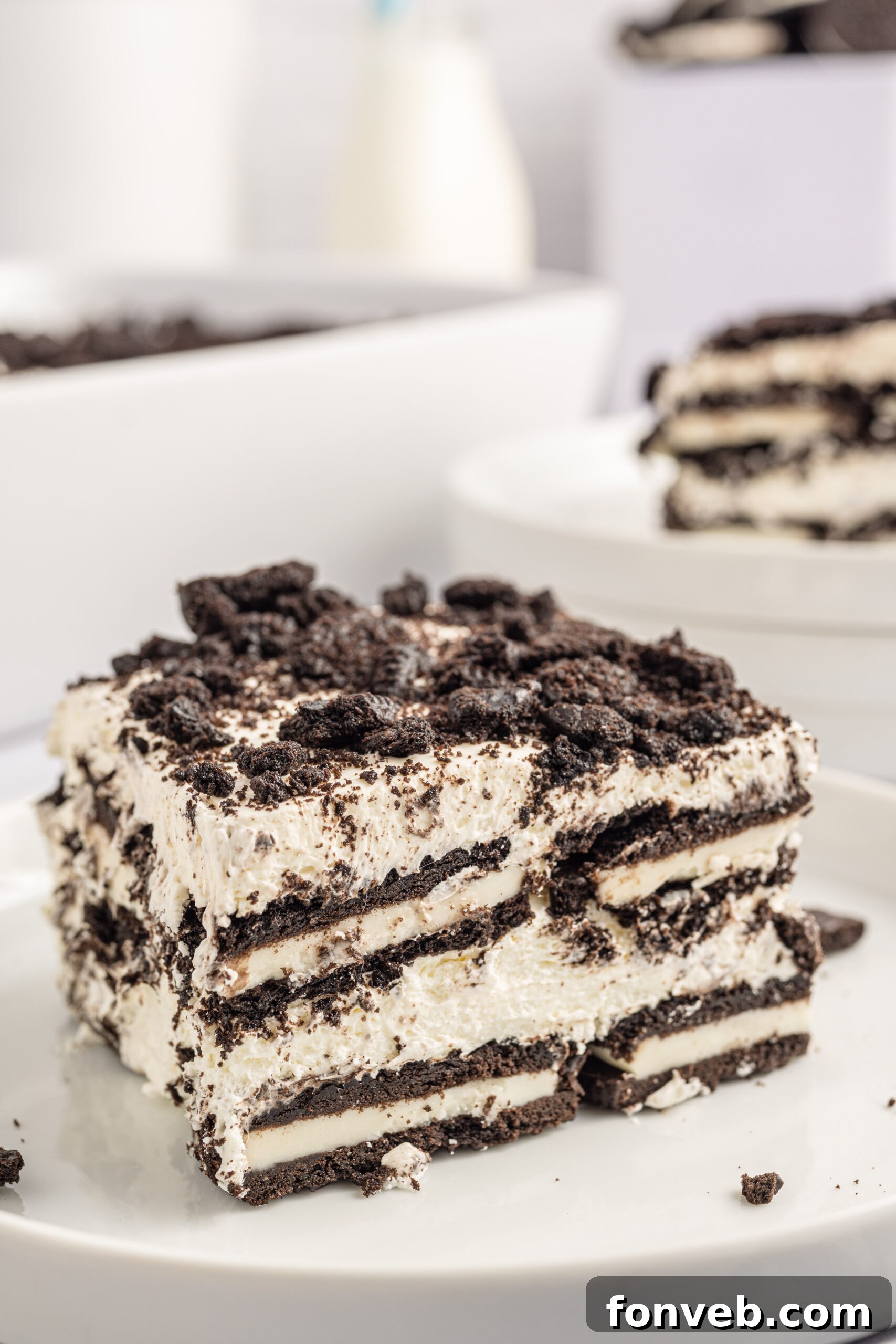 Front view of a slice of Oreo Icebox Cake on a white plate.