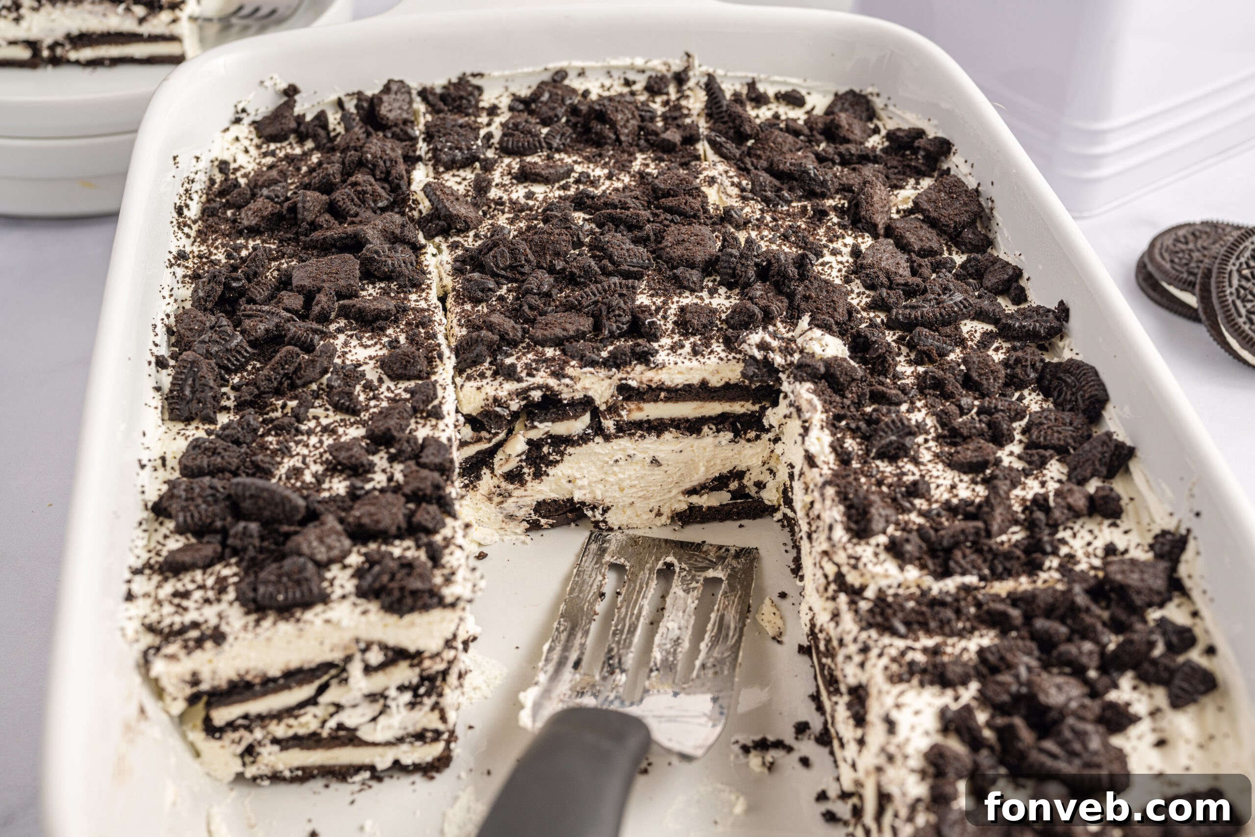 Front view of a slice of Oreo Icebox Cake on a silver cake server.