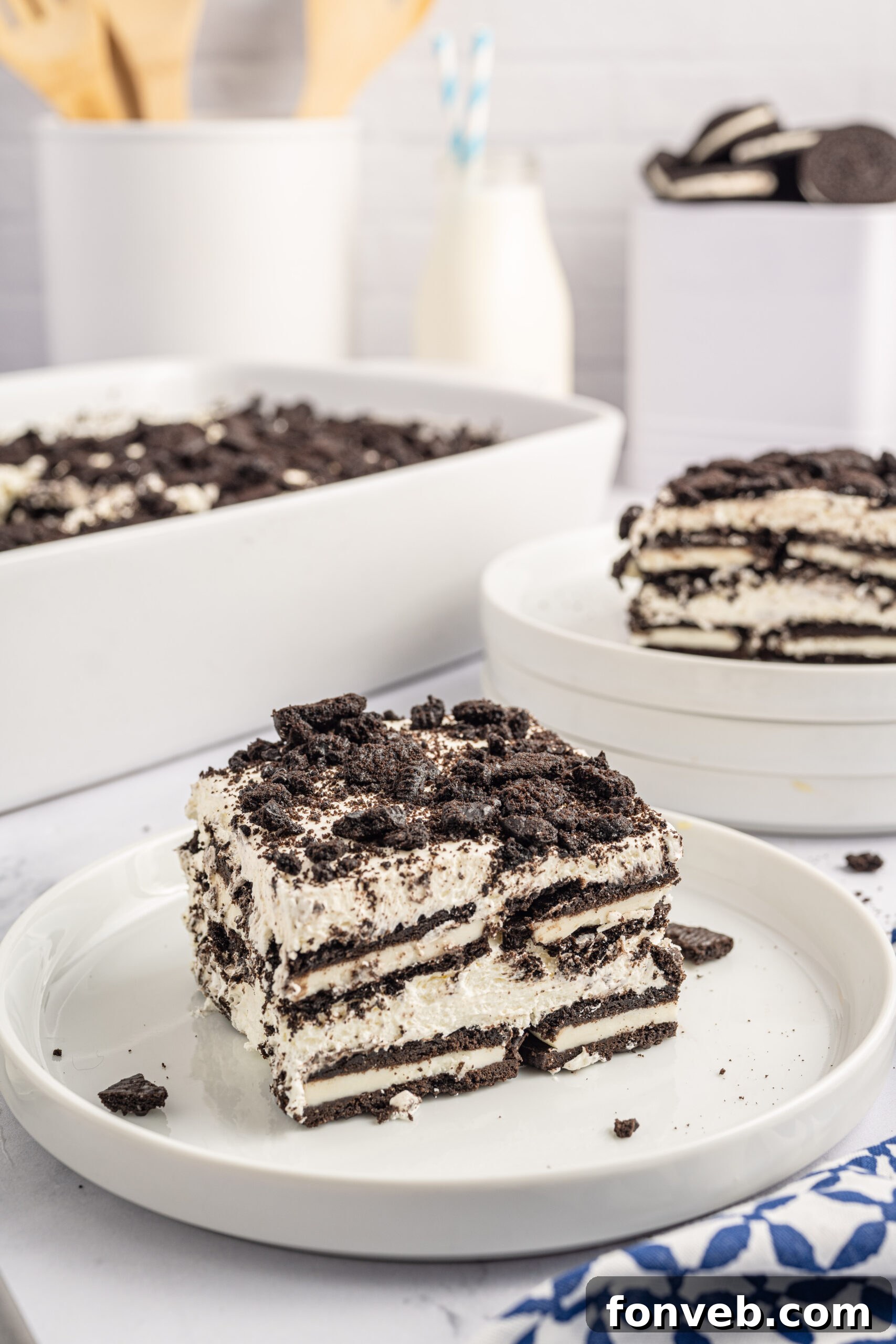 Front view of a slice of Oreo Icebox Cake on a white plate.