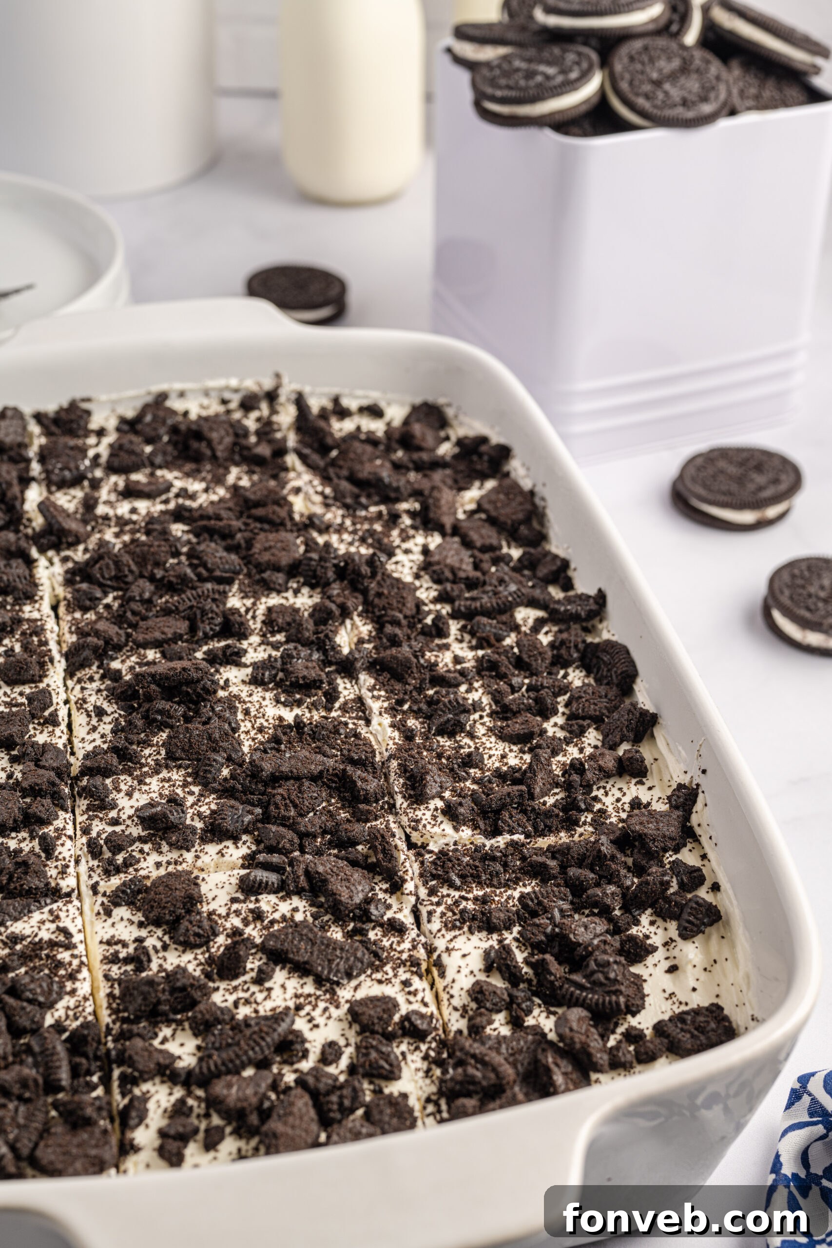 Overhead view of Oreo Icebox Cake, cut into slices, in a white baking dish.