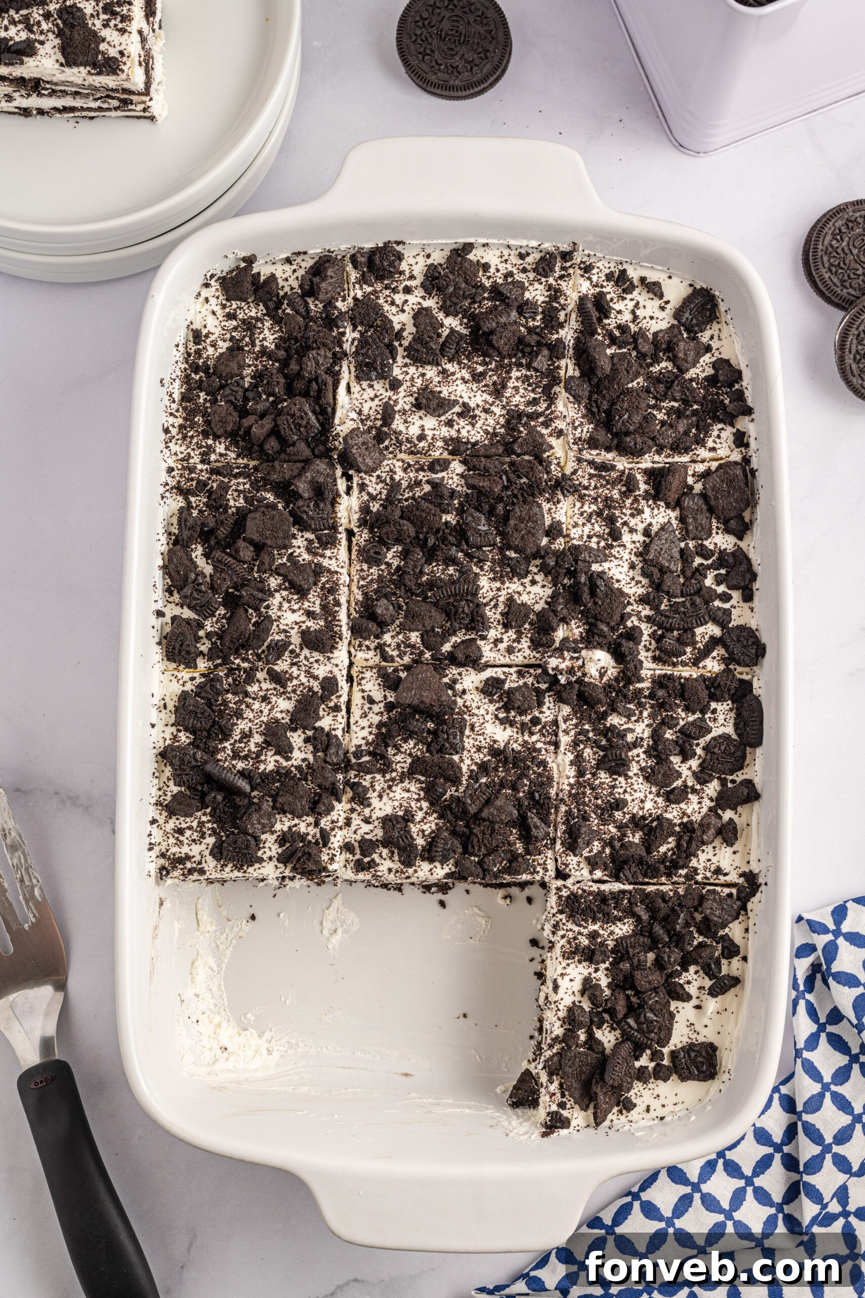 Overhead view of Oreo Icebox Cake, cut into slices, in a white baking dish.