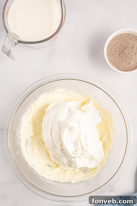 Step-by-step image of pressing the Oreo crust into the baking dish.