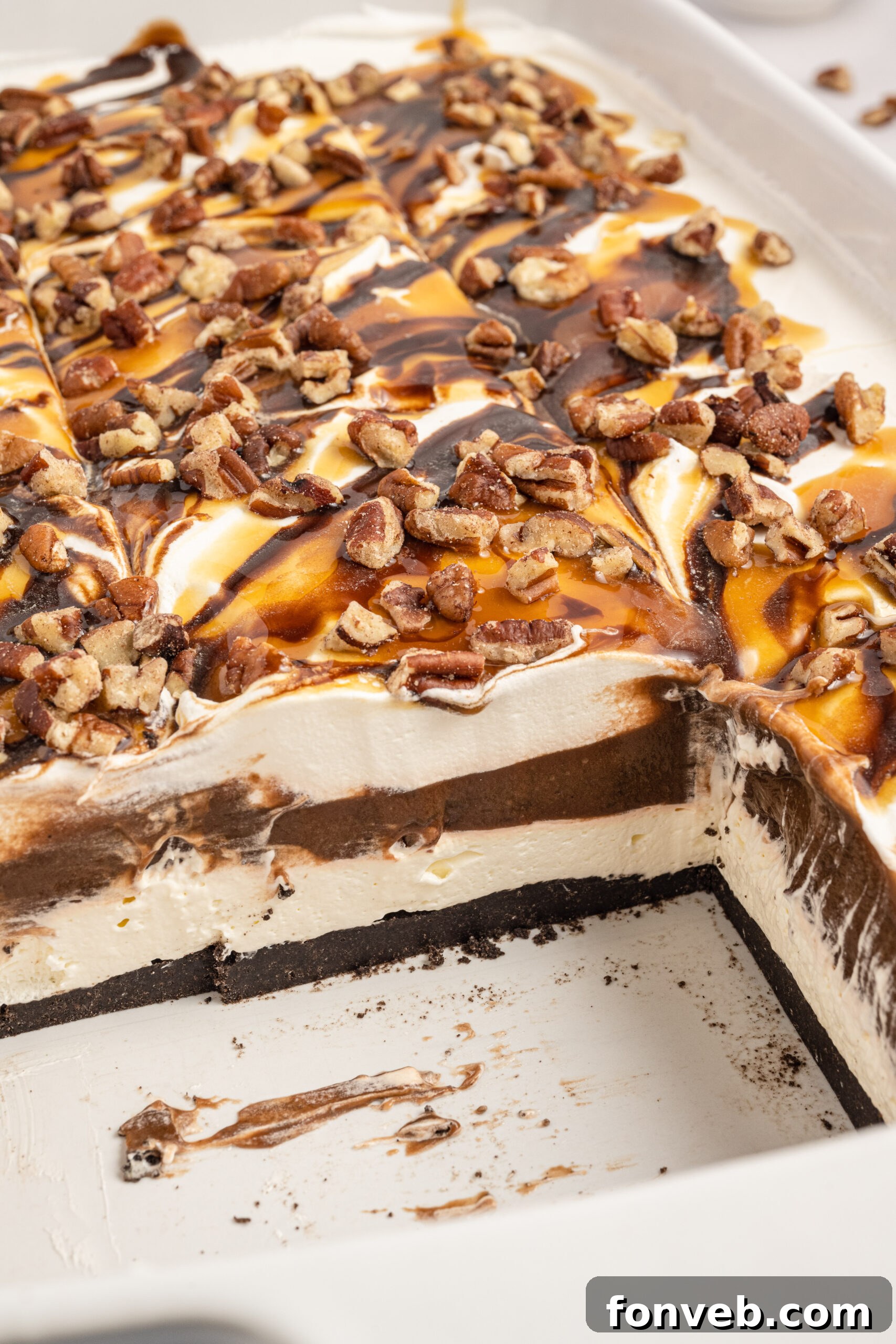Close up view of Turtle Lush in a white baking dish, showing the clean layers after two slices have been removed.