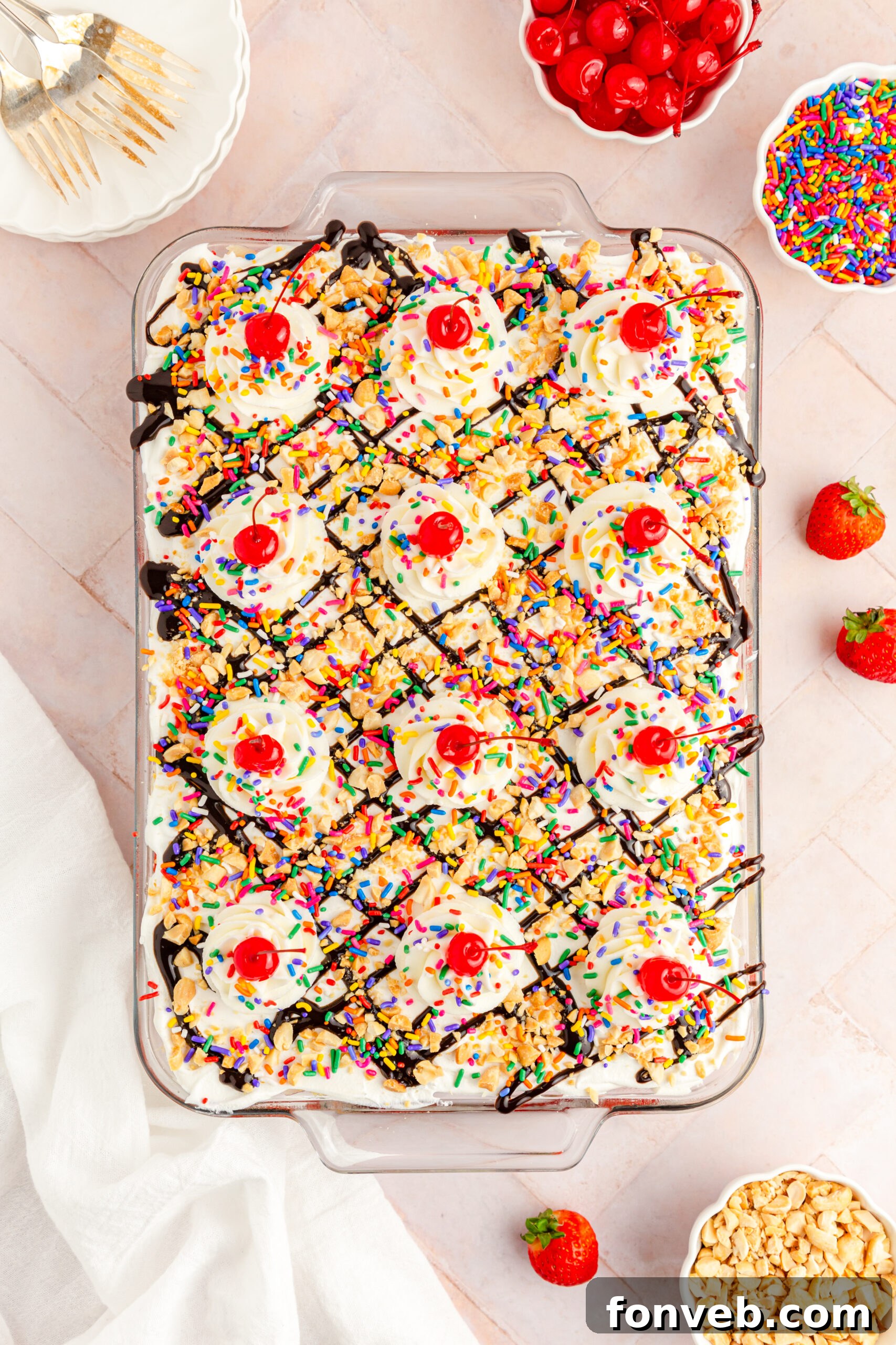 An overhead view of the full No-Bake Banana Split Cake, beautifully assembled in a clear glass baking dish, ready to be served.