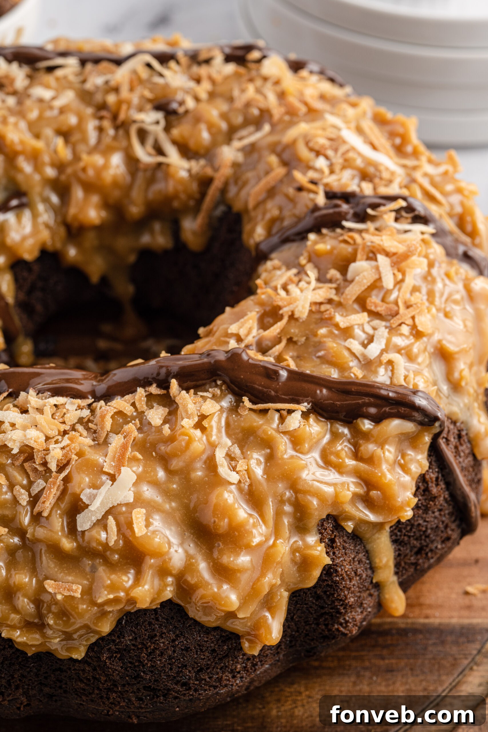 Close up view of Samoa Cake on a wooden cutting board.