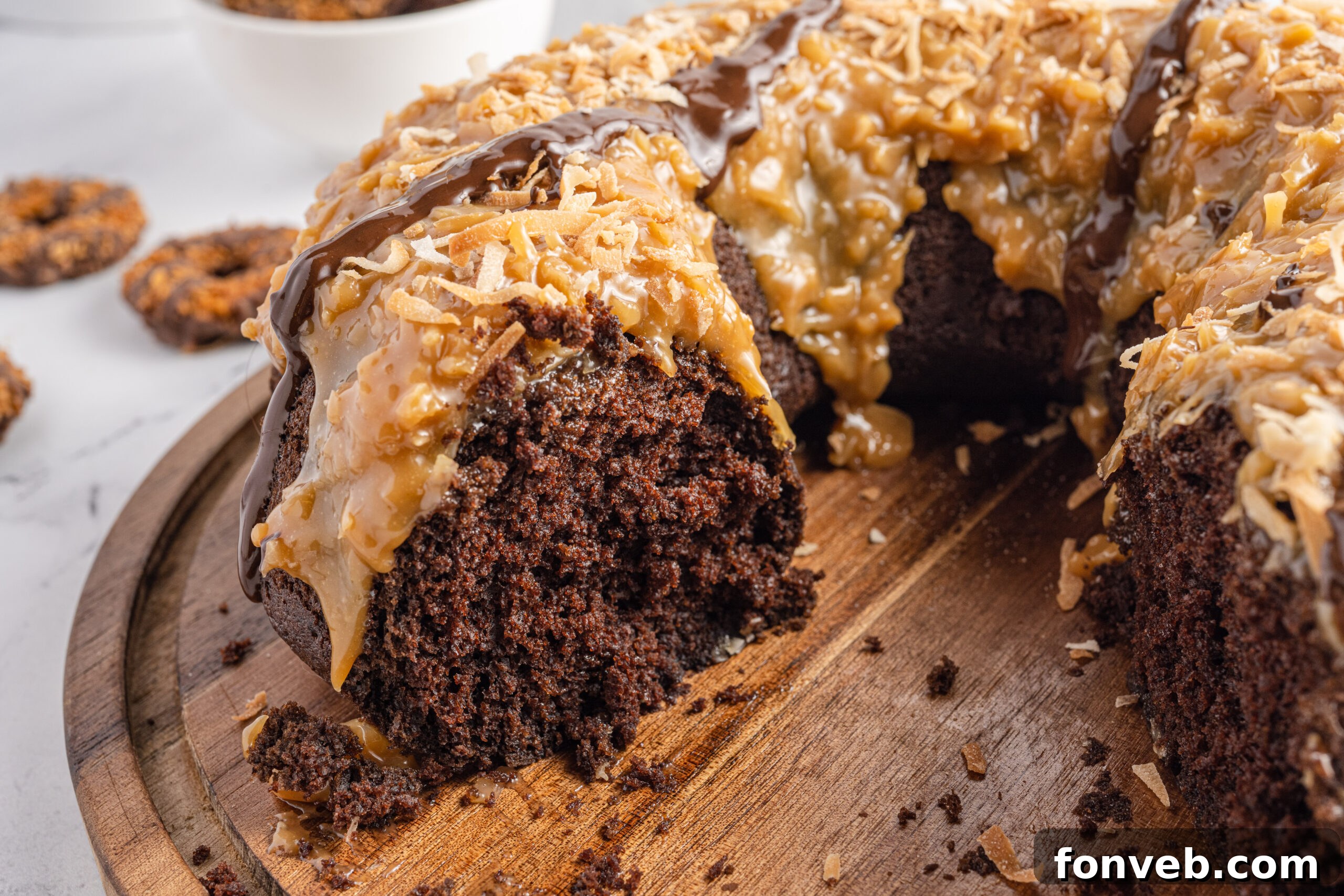 Close up view of Samoa Cake on a wooden cutting board.