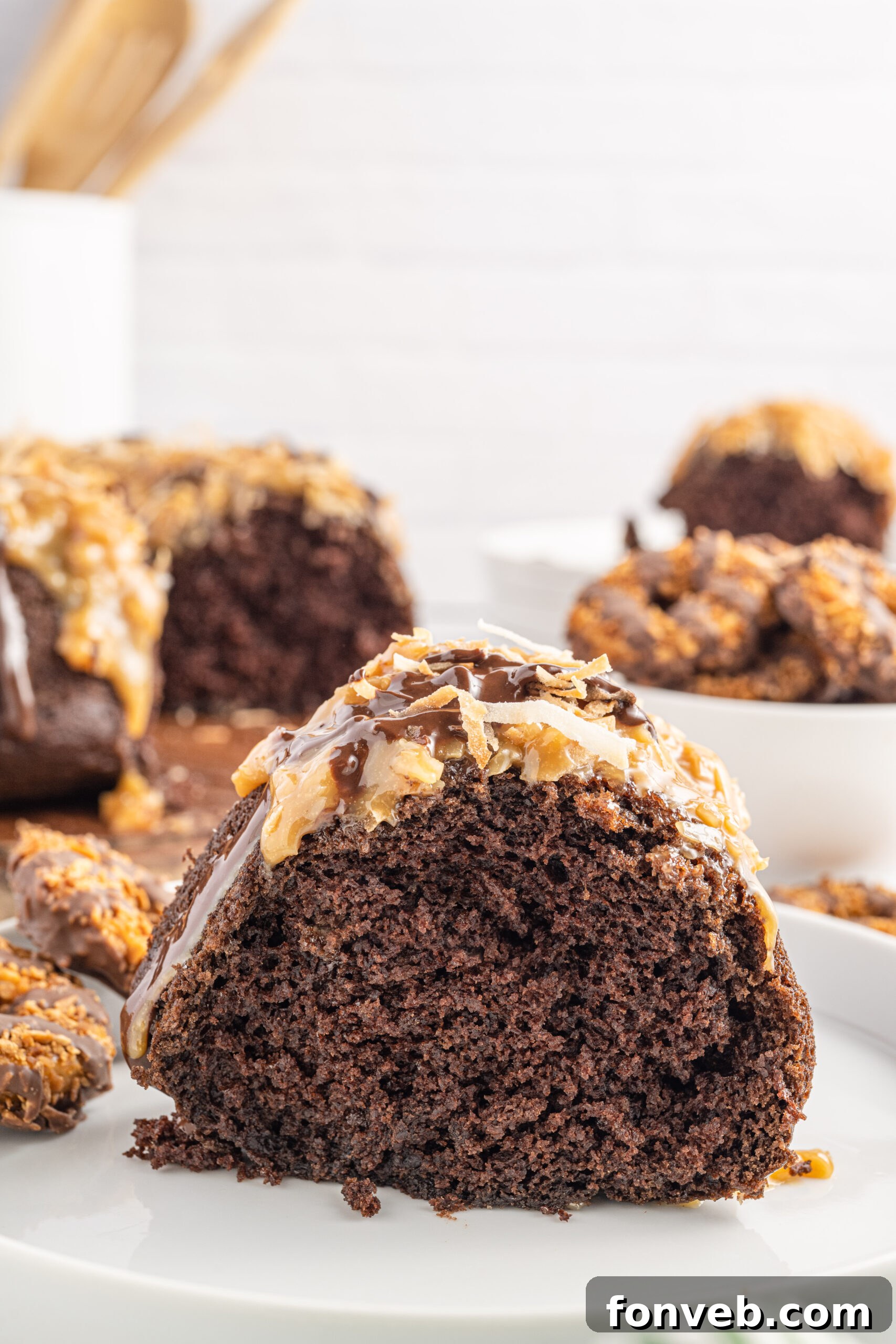 Side view of a slice of Samoa Cake on a white plate.
