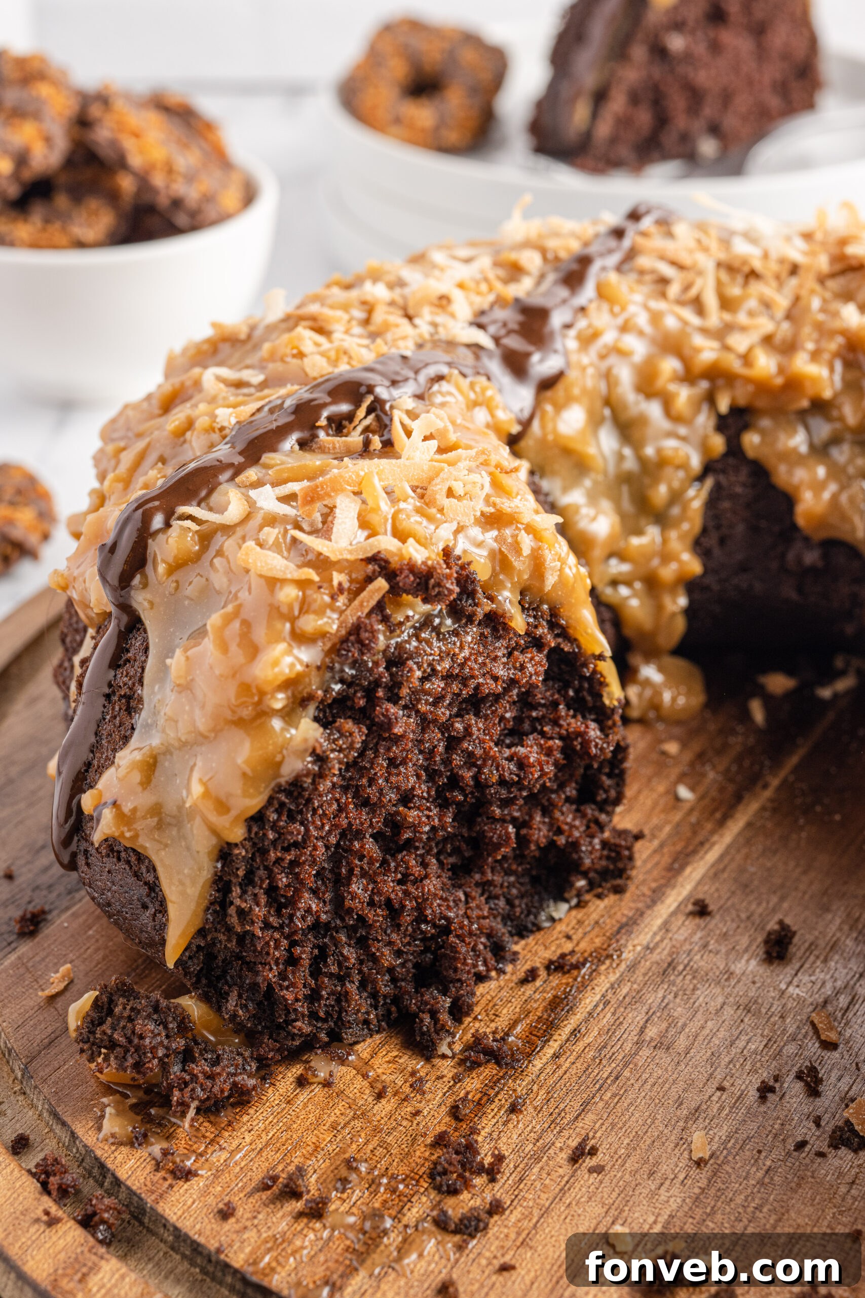 Samoa Cake on a wooden board with a slice missing showing the inside texture 