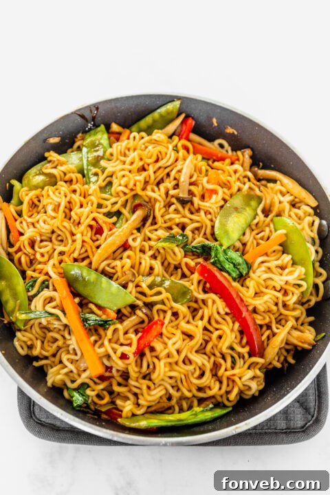 Red pepper flakes being added to a bowl of sauce.
