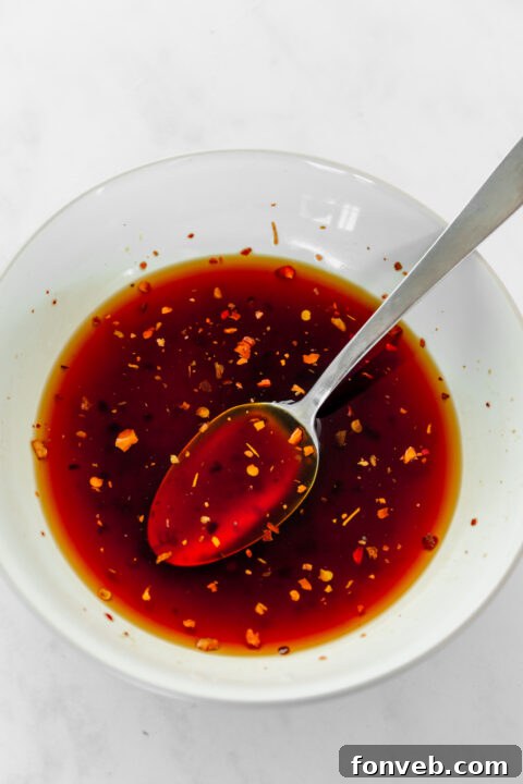 Teriyaki sauce being poured into a bowl.