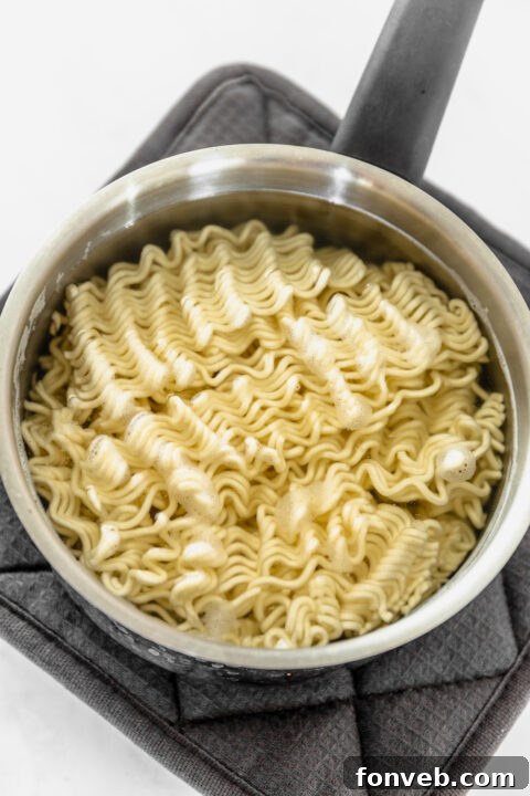 Water being added to a bowl of sauce.