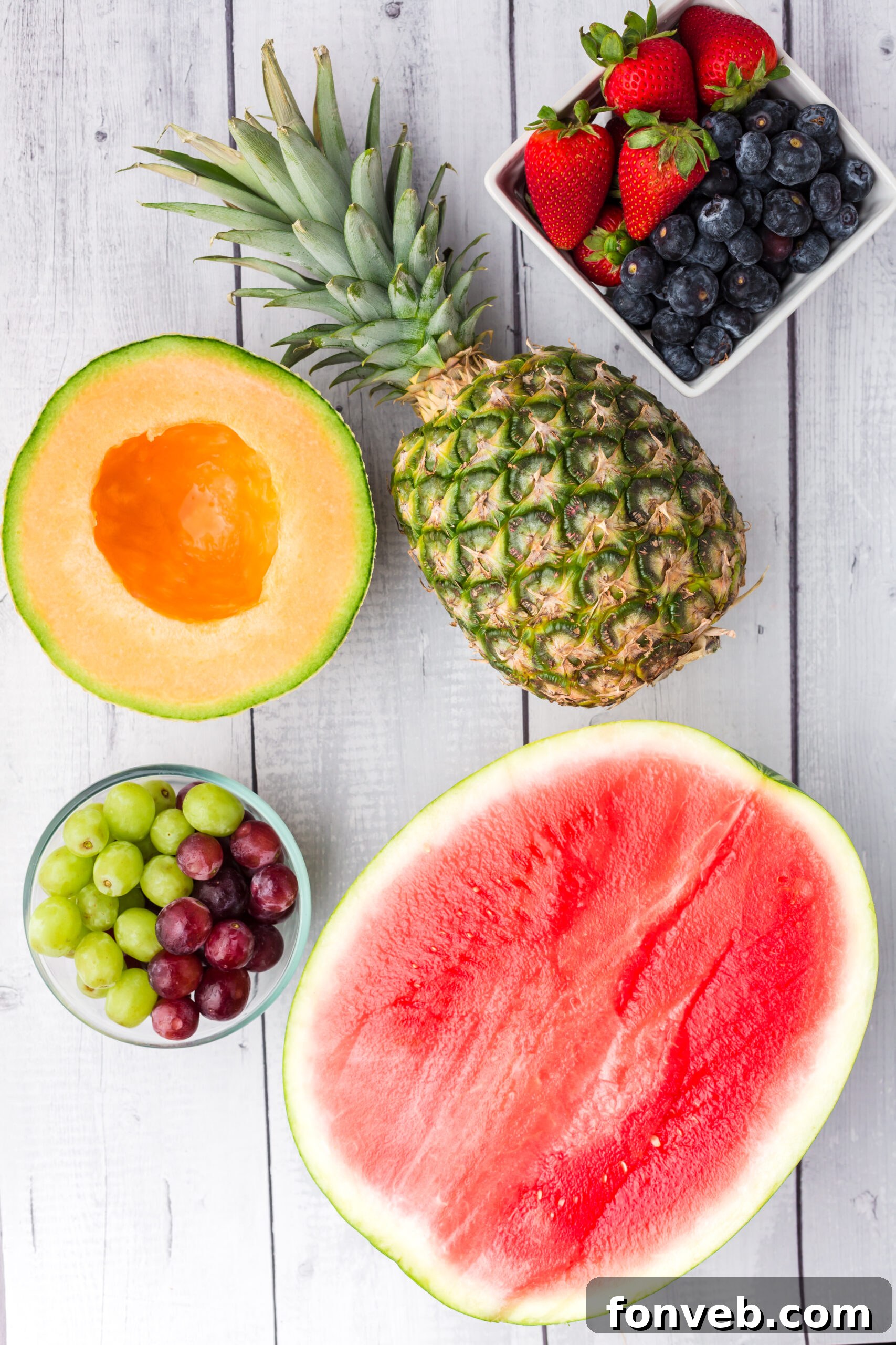 Overhead view of all the fresh ingredients laid out, ready to be prepared for the Watermelon Turtle Fruit Salad.
