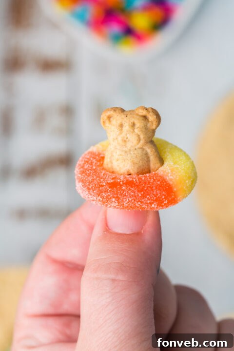 A close up of the Teddy Graham bear in the gummy ring, floating on the blue pudding.