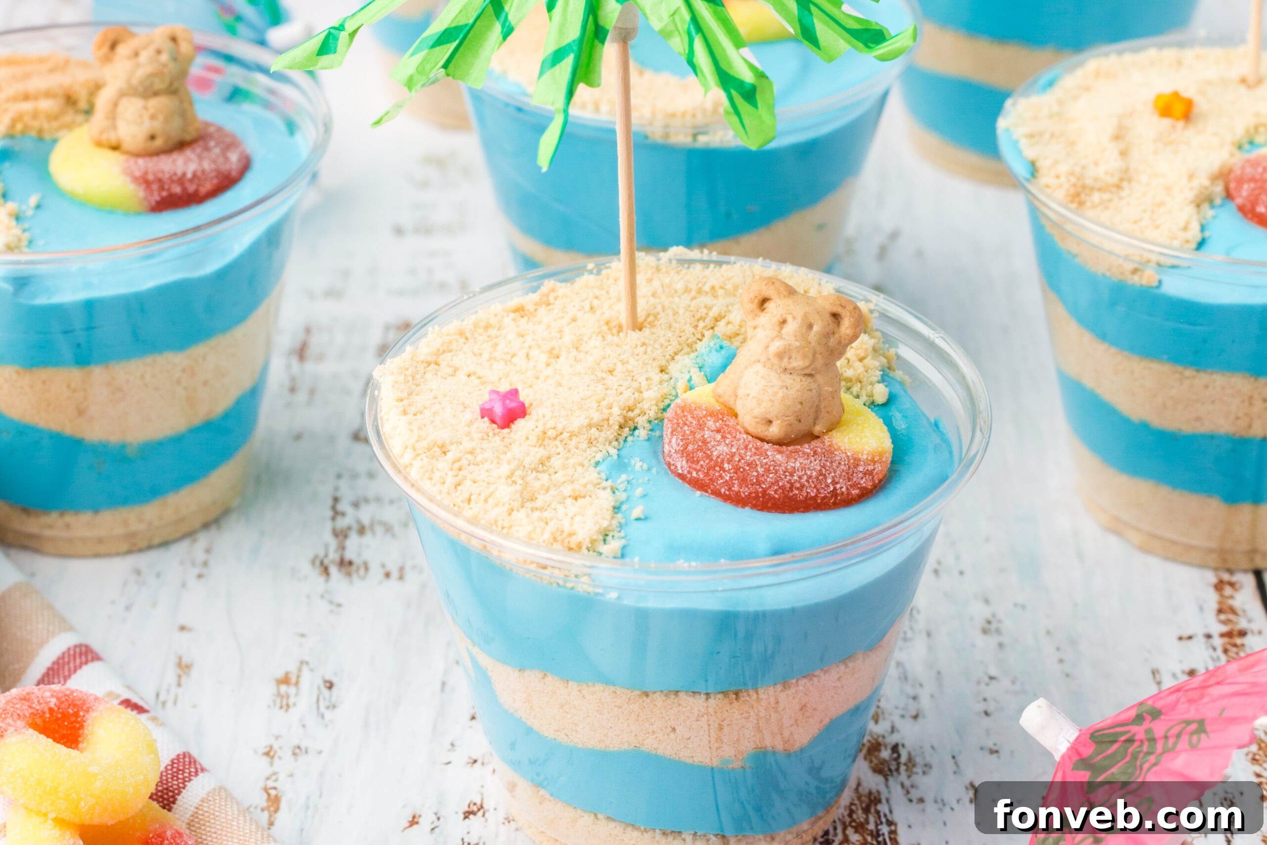 Front view of a row of Beach Cheesecake Pudding Cups, ready to be served.