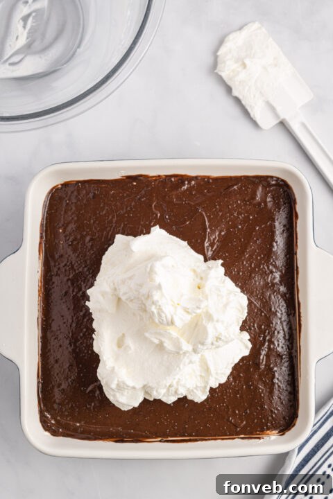 Chocolate pudding being whisked with cold milk.