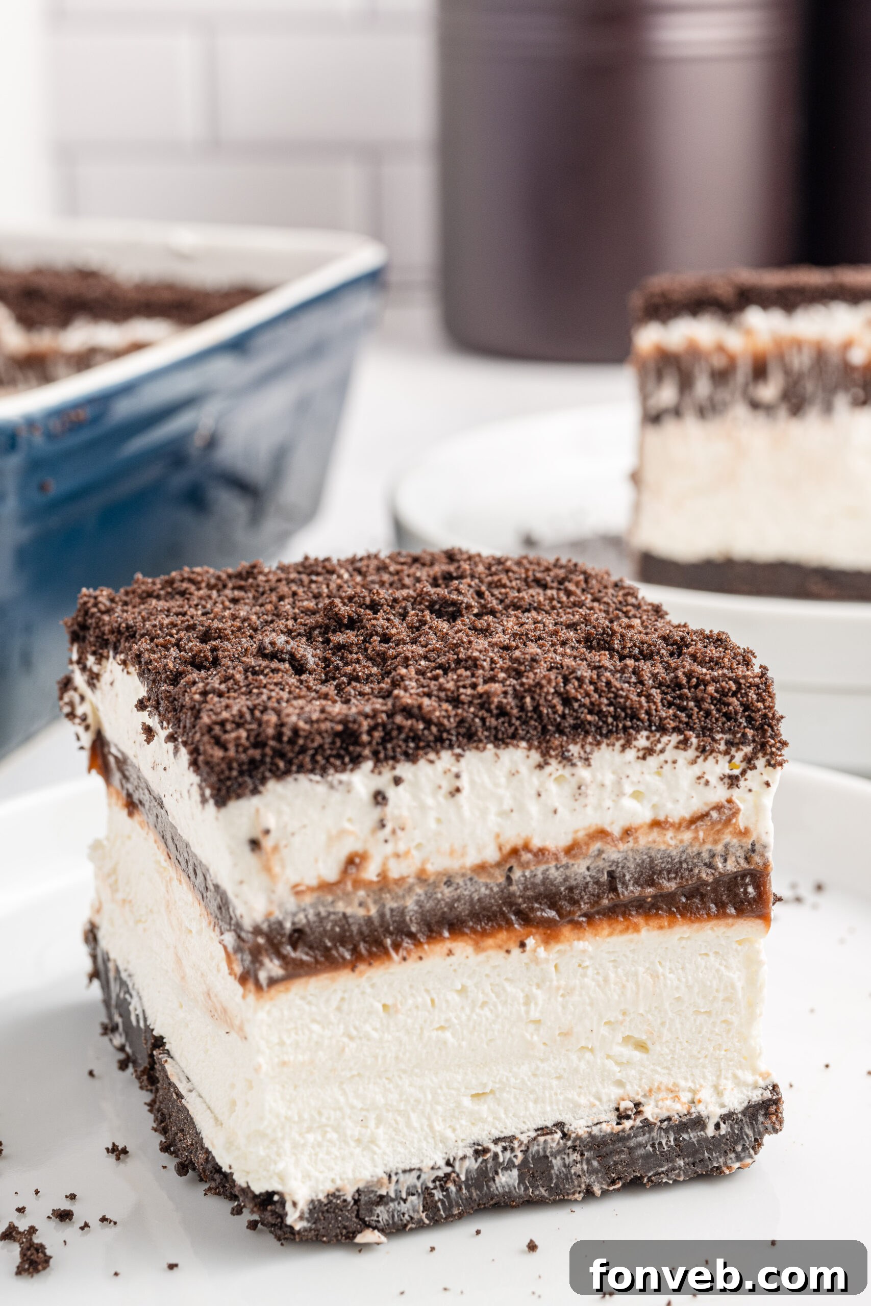 Front view of a slice of Oreo Delight on a white plate.