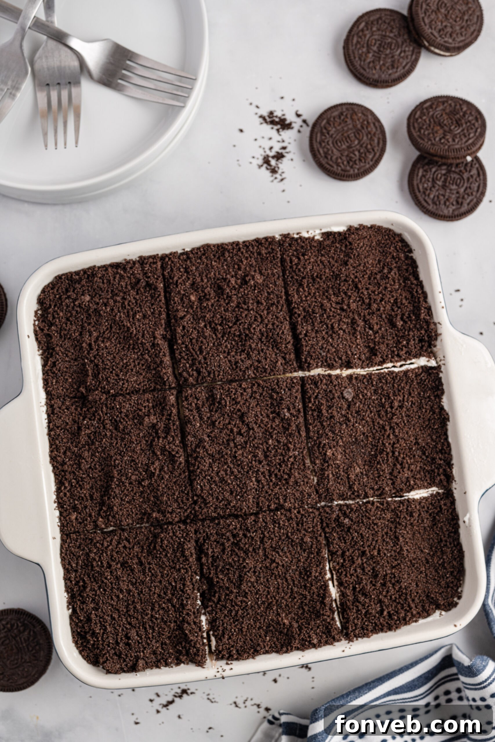 Overhead view of Oreo Delight in a baking dish cut into nine slices.