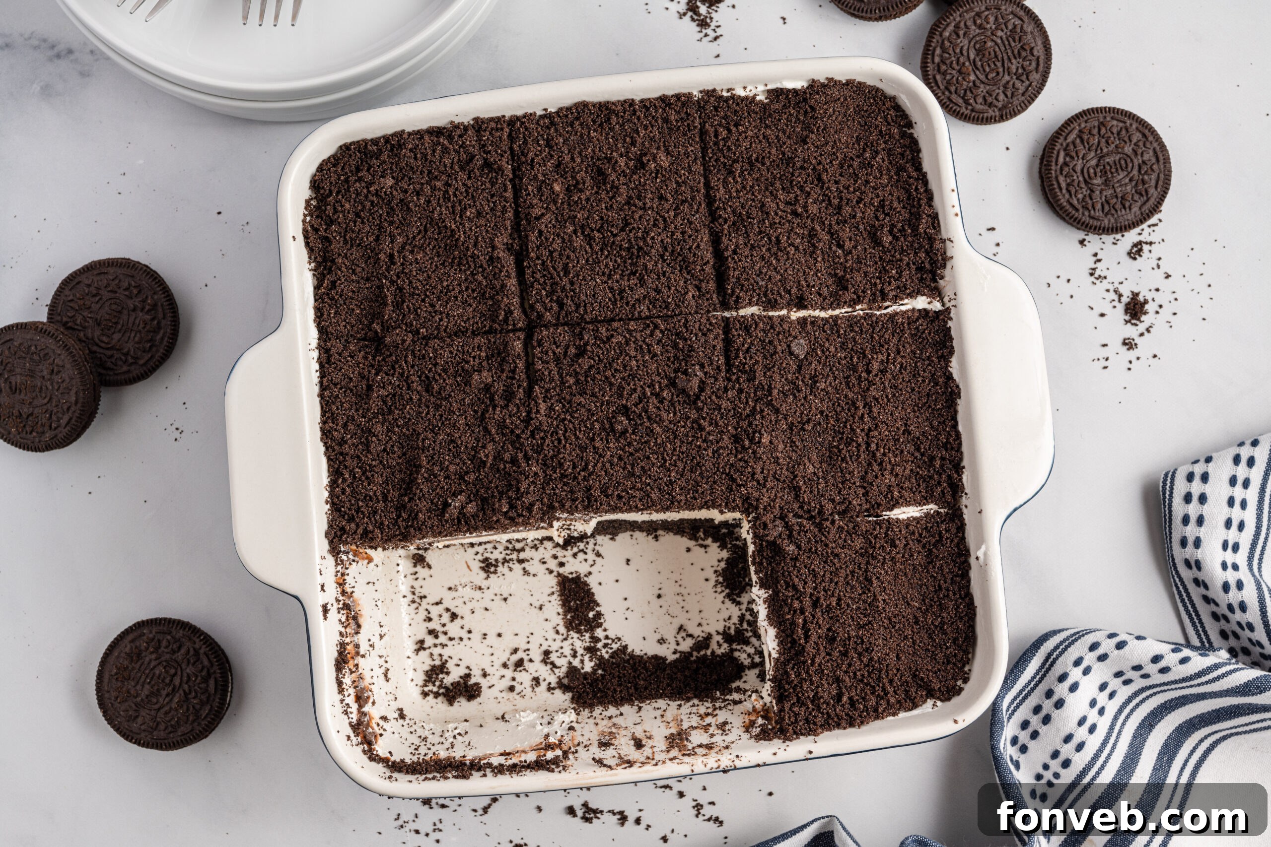 Overhead view of Oreo Delight in a baking dish cut into slices with two removed.