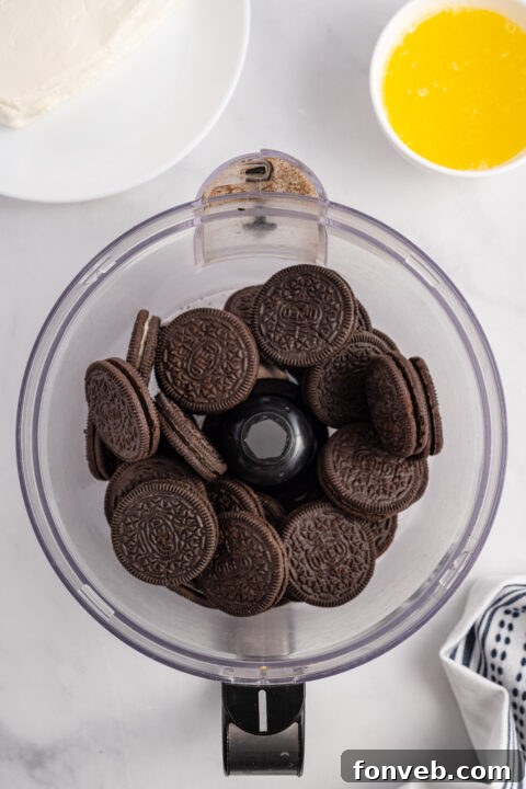 Crushed Oreo cookies mixed with melted butter for the base layer.