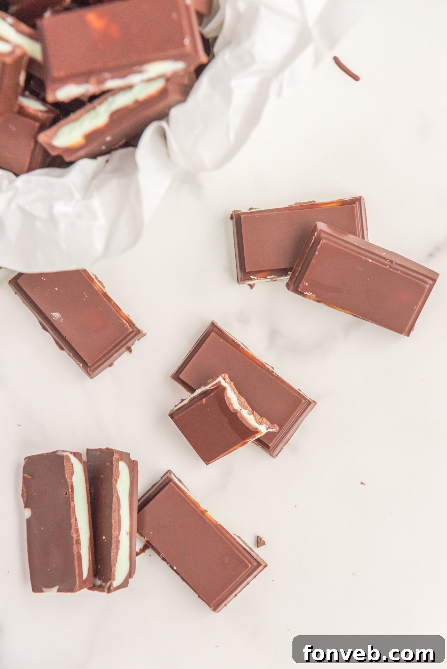 Overhead view of Homemade Andes Mints stacked with a bite removed from one mint.