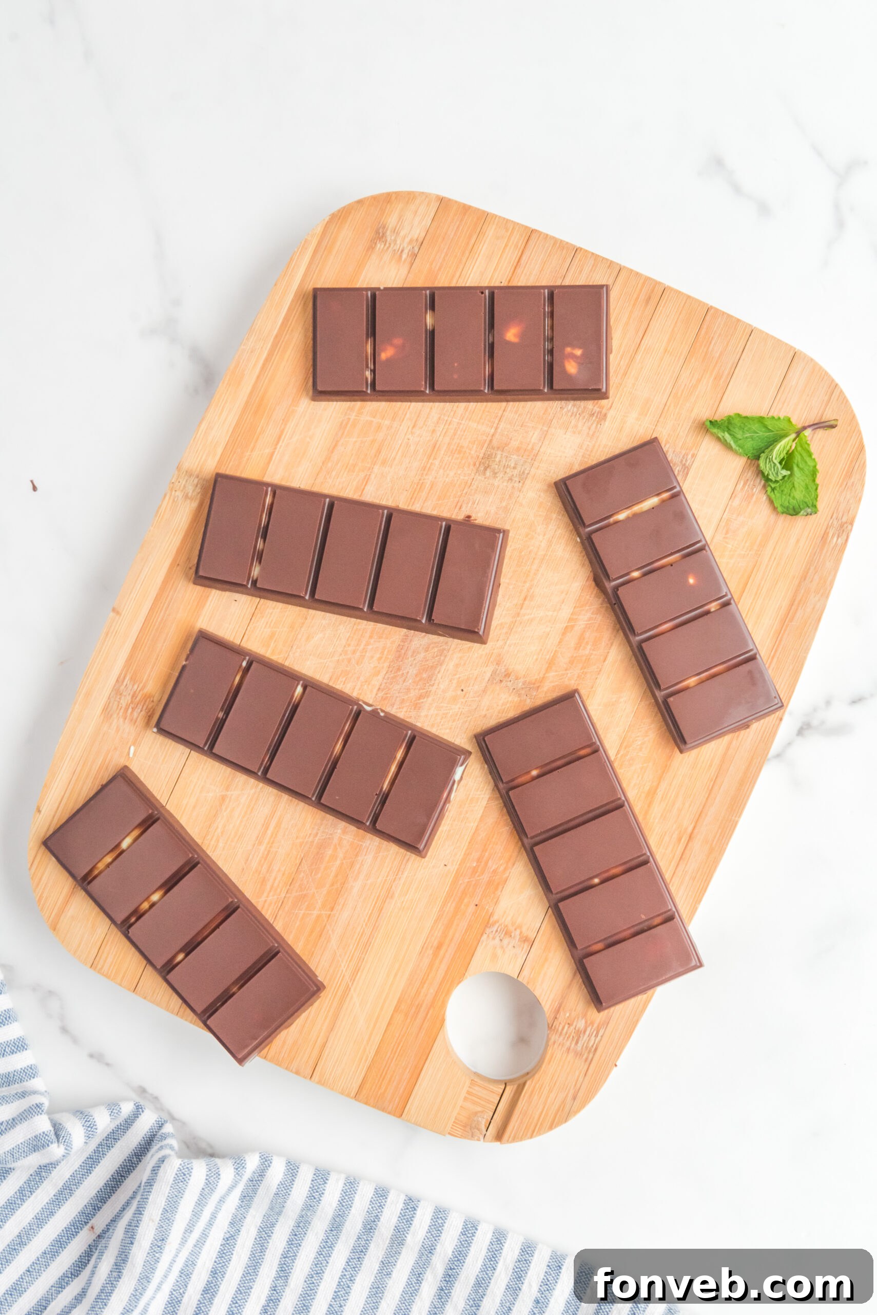 Overhead view of Homemade Andes Mints on a wooden cutting board.