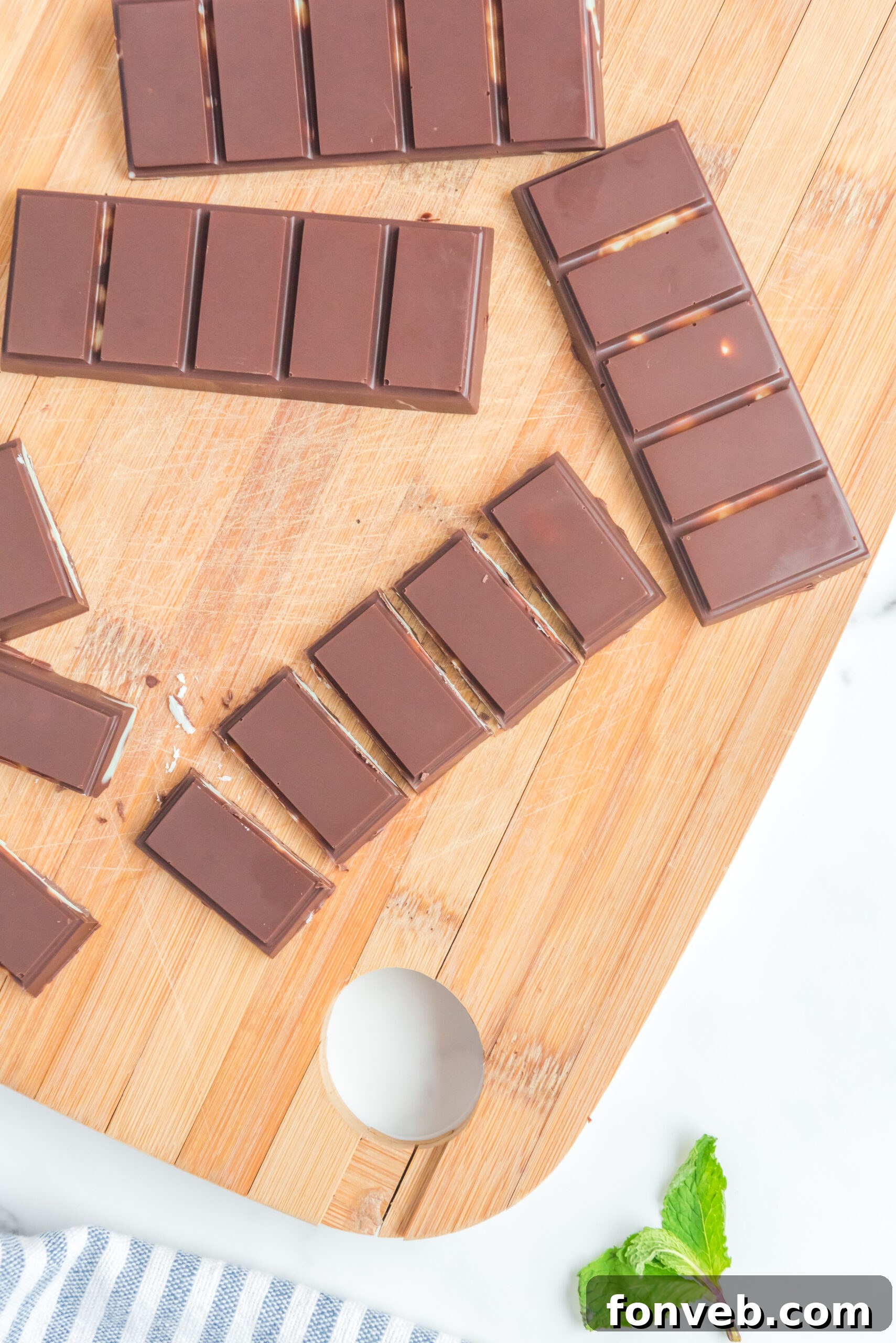 Overhead view of Homemade Andes Mints on a wooden cutting board.