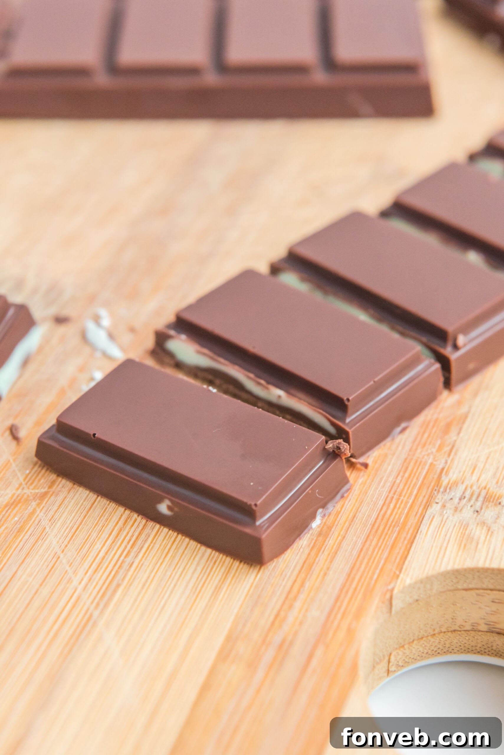 Front view of Homemade Andes Mints on a wooden cutting board.