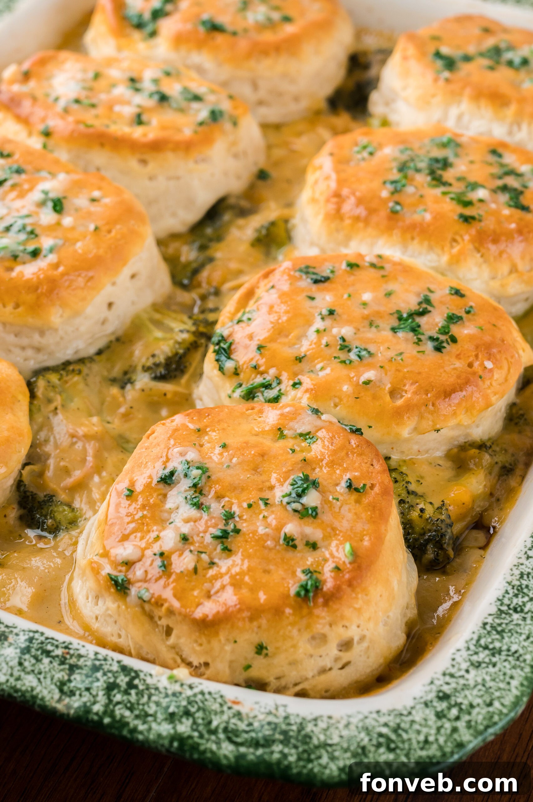 Close up view of Broccoli Cheddar Biscuit Casserole in a baking dish.