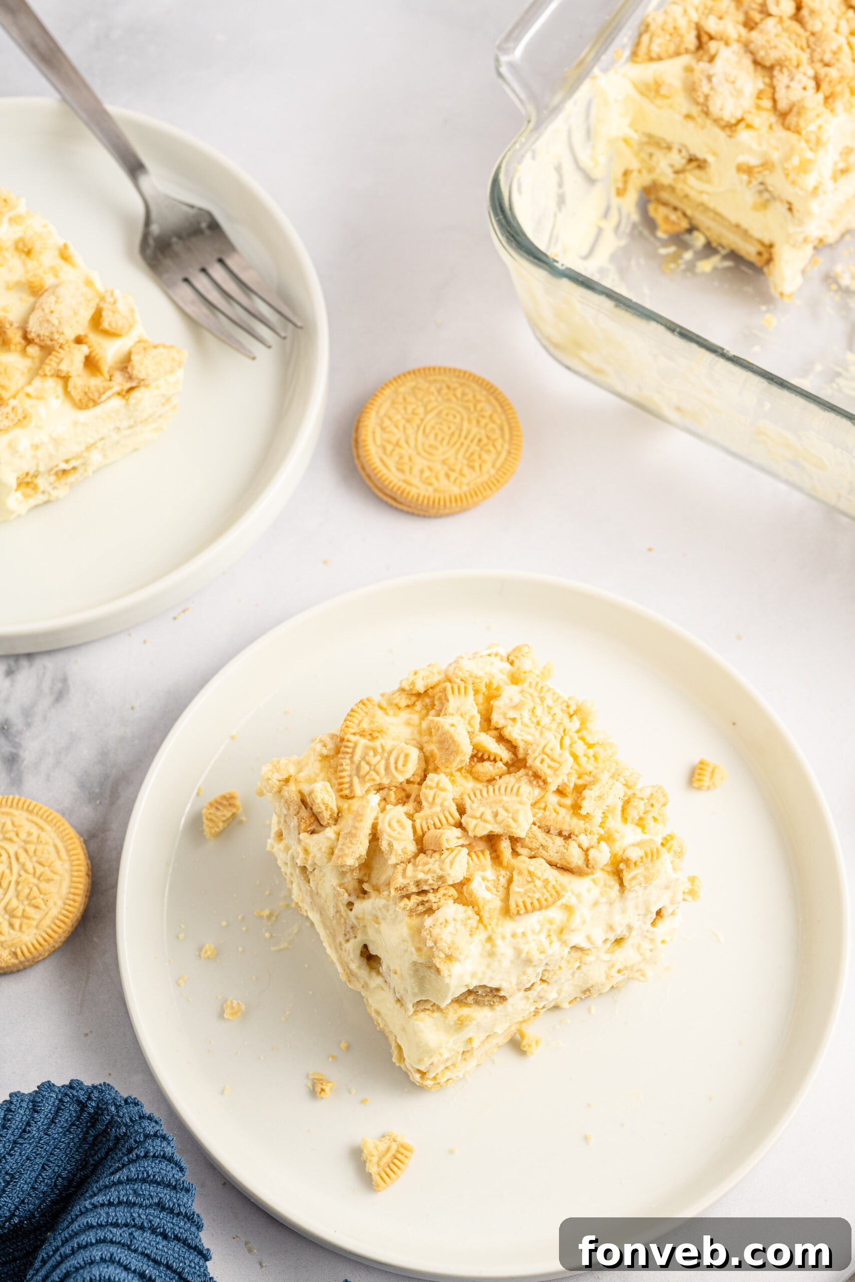 Golden Oreo No-Bake Delight 16 Overhead view of a slice of Golden Oreo Icebox Cake on a white plate.