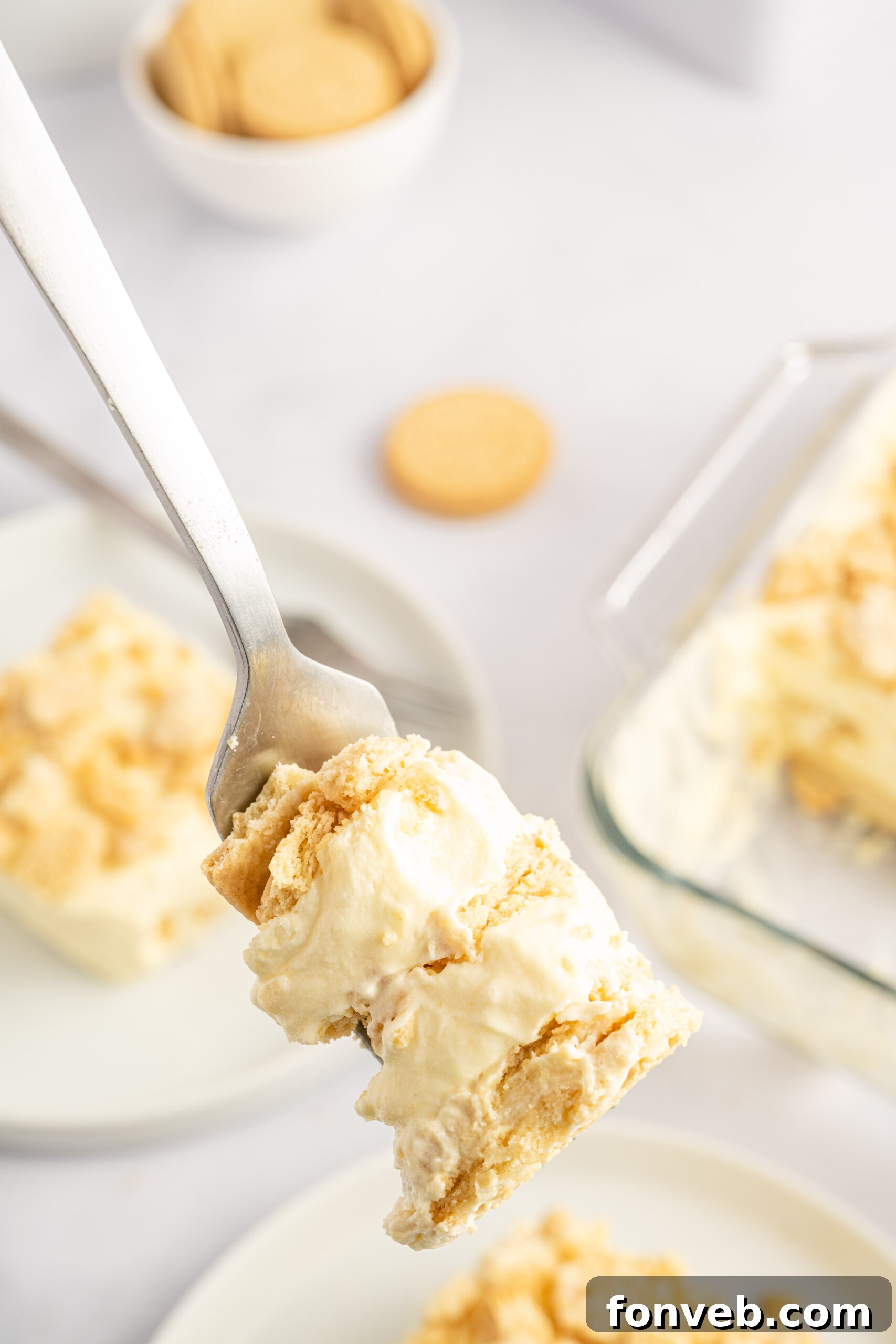 Golden Oreo No-Bake Delight 19 Close up view of a bite of Golden Oreo Icebox Cake on a silver fork.