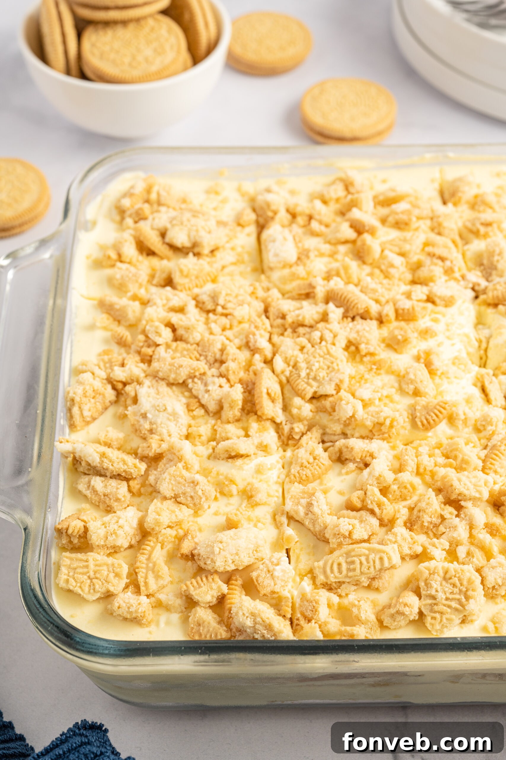 Golden Oreo No-Bake Delight 4 Close up view of Golden Oreo Icebox Cake in a clear baking dish.