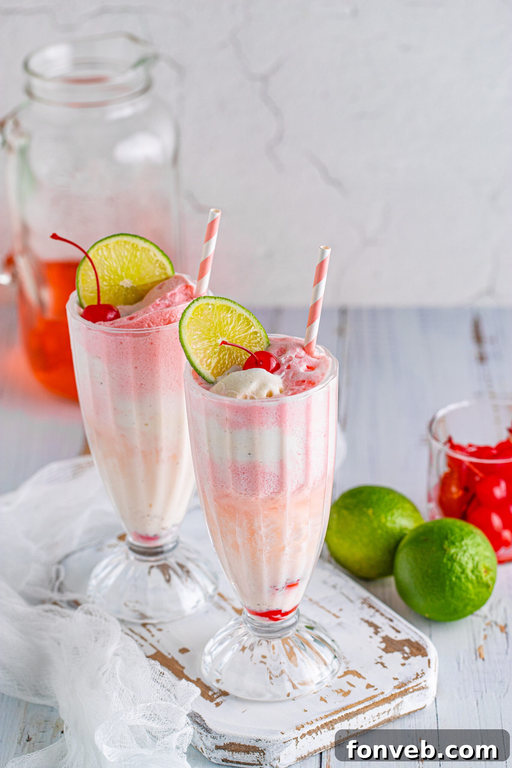 Front view of Dirty Shirley Float in a clear glass topped with a lime slice and cherry.