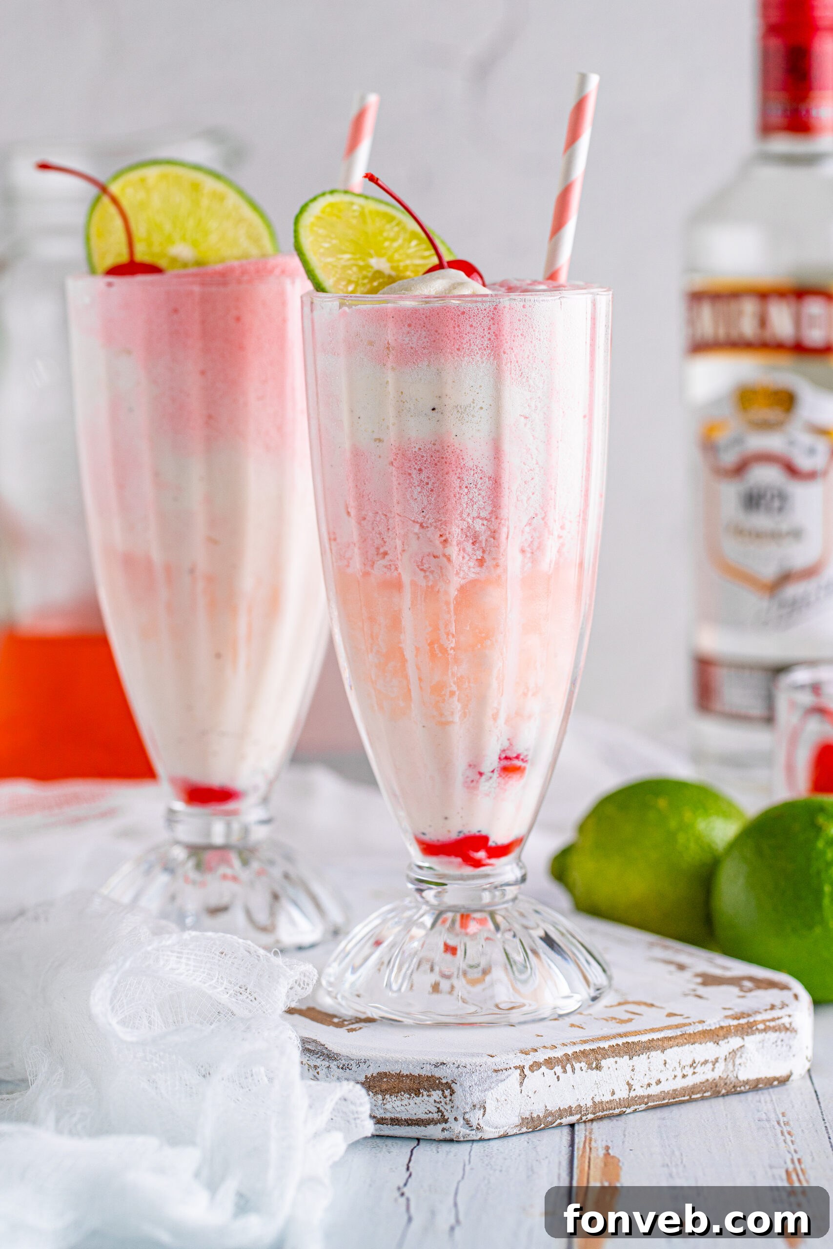 Front view of Dirty Shirley Float in a clear glass topped with a lime slice and cherry.