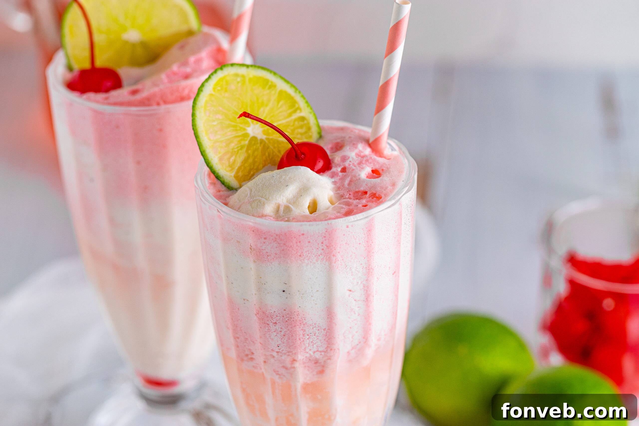 Front view of Dirty Shirley Float in a clear glass topped with a lime slice and cherry.