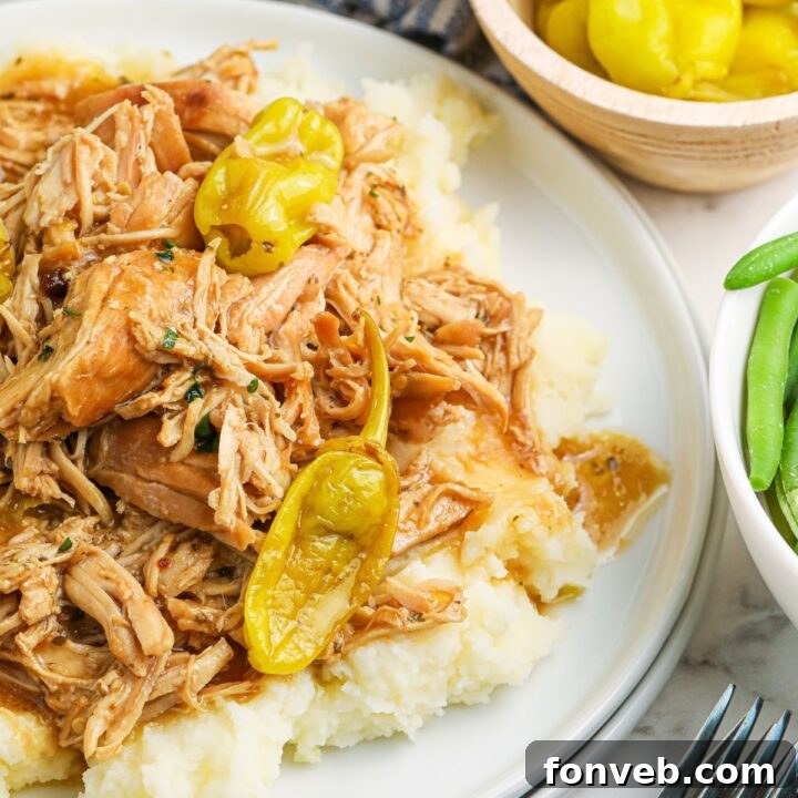 Slow Cooker Mississippi Chicken on plate with mashed potatoes 