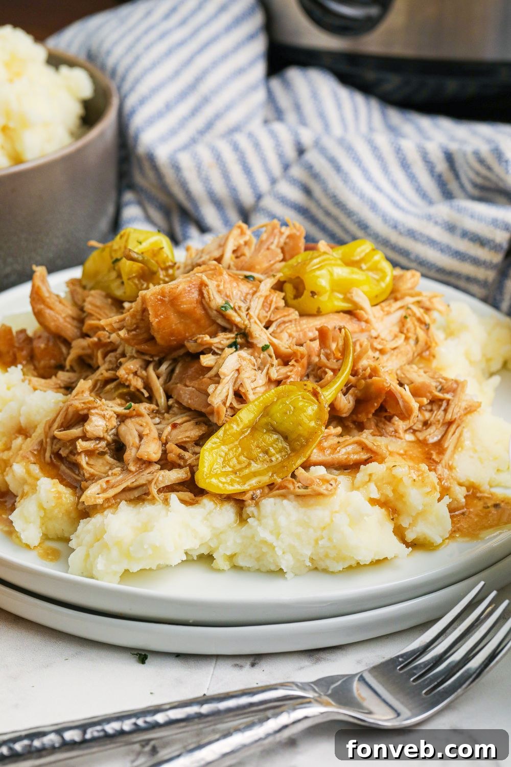 mississippi chicken on plate with forks in front
