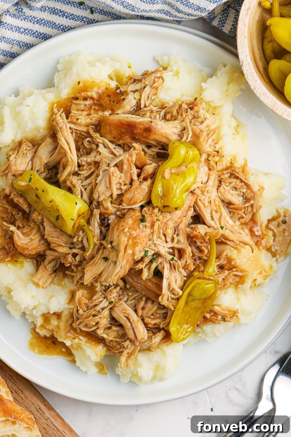 chicken shredded with pepperso n plate with mashed potatoes underneath