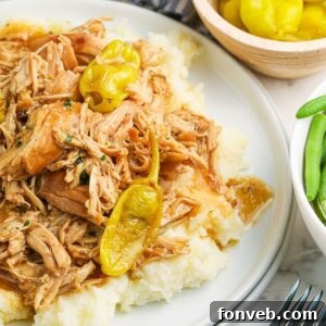 Slow Cooker Mississippi Chicken on plate with mashed potatoes
