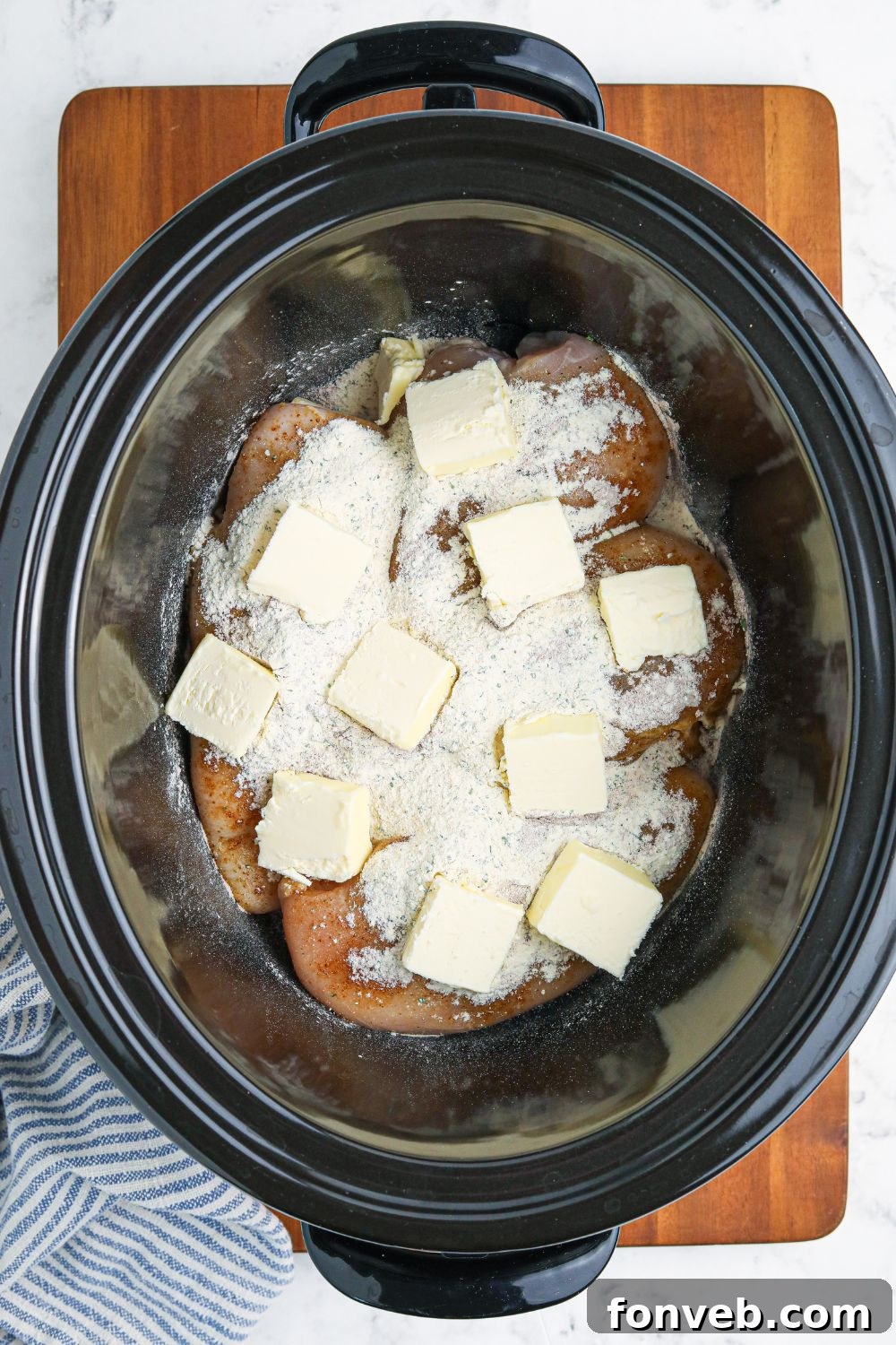 seasoning and butter on top of chicken 