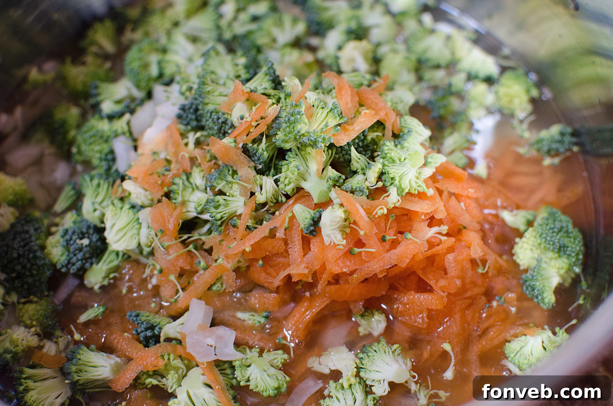 Fresh broccoli florets, carrots, and onions ready for soup