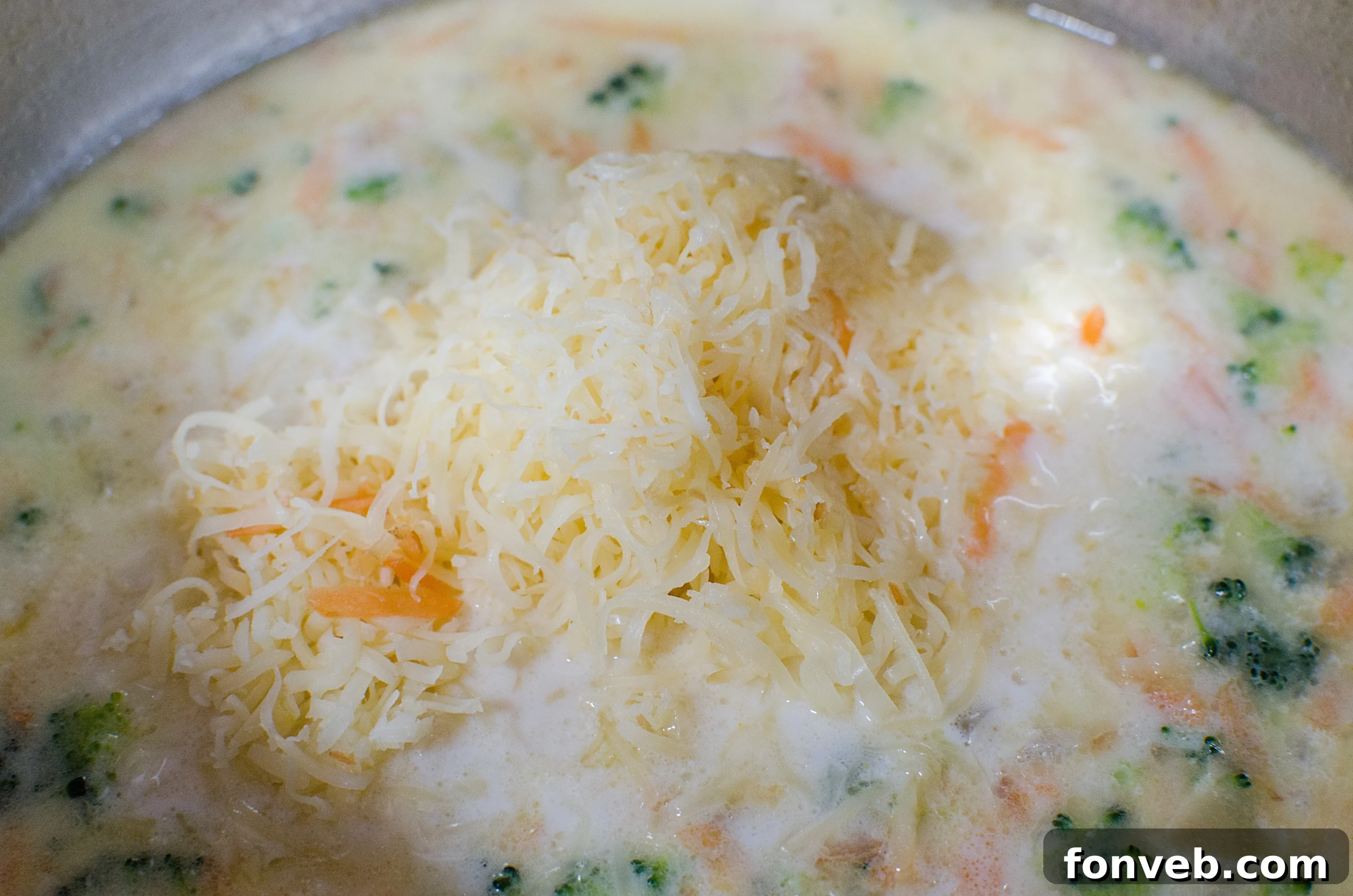 Freshly grated cheddar and asiago cheese for a rich soup
