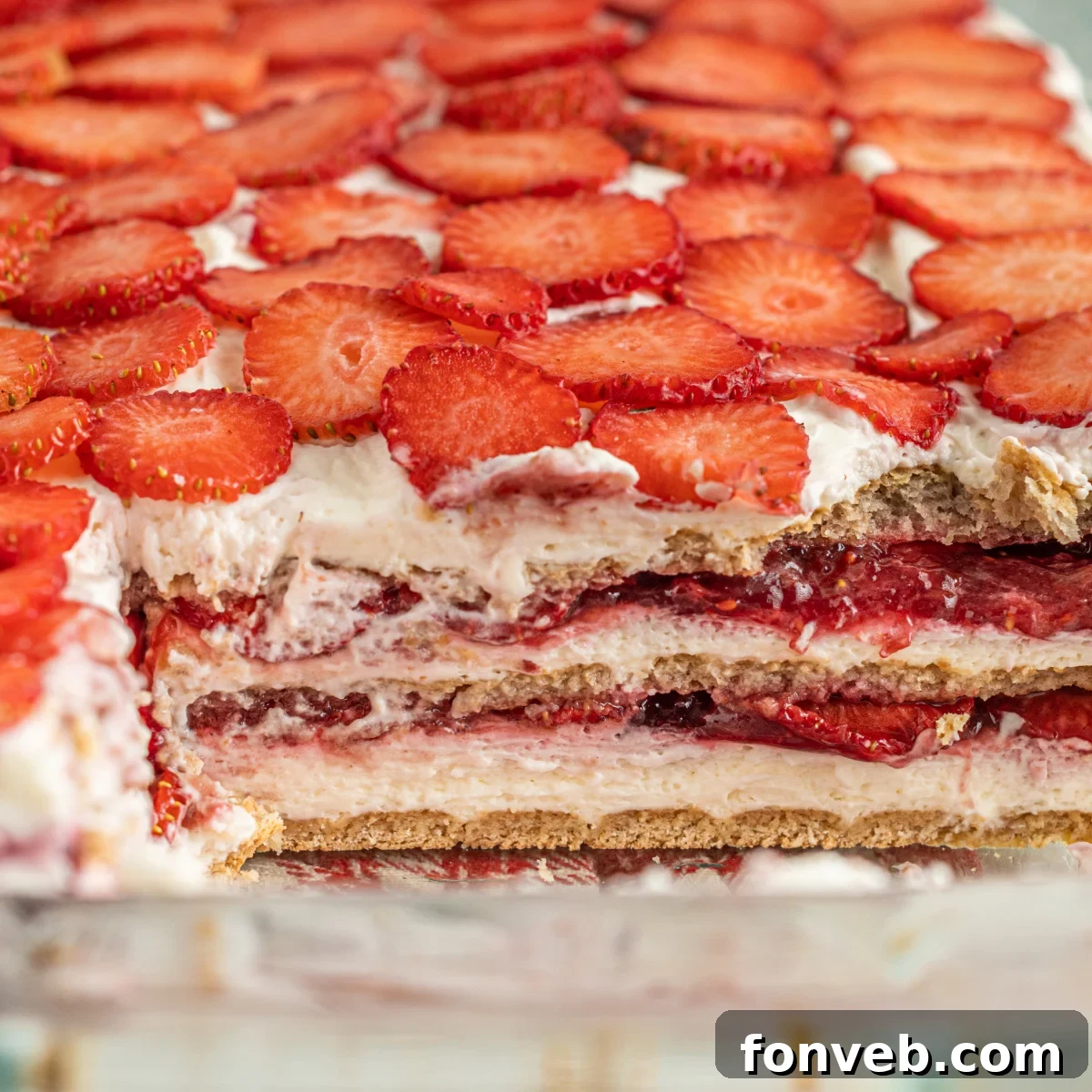 strawberry cheesecake icebox cake up close with a slice removed to show the layers 