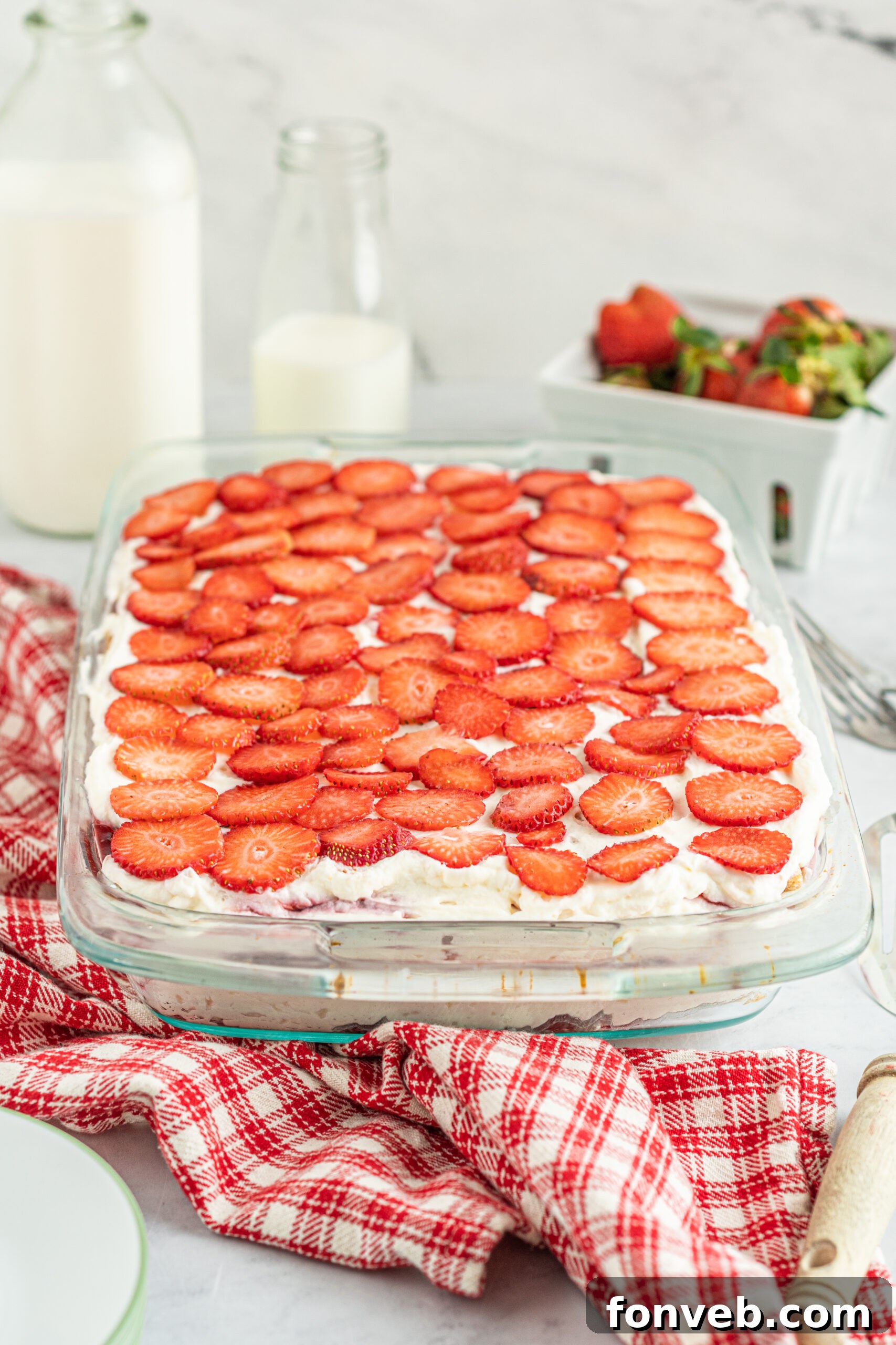 Side view of Strawberry Icebox Cake in a clear baking dish. 