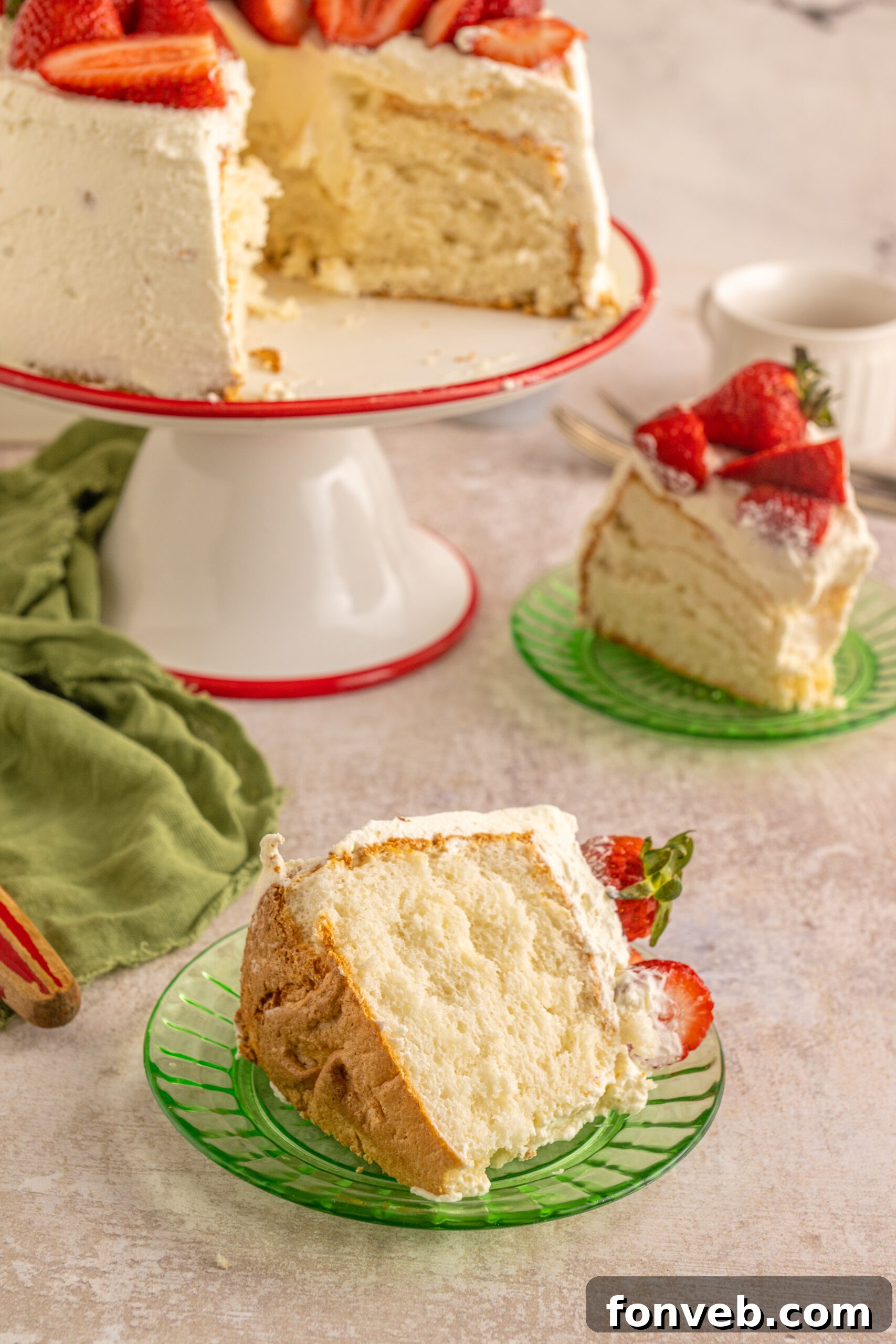 A piece of Strawberry Angel Food Cake on a green plate. 